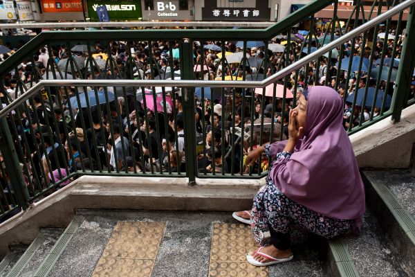 HONG KONG, CHINA - 2019/07/21: An immigrant domestic helper rests...