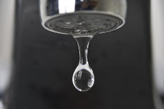 Gota de agua cayendo de un grifo.