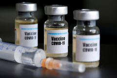 FILE PHOTO: FILE PHOTO: Small bottles labbeled with a " lt;HIT gt;Vaccine lt;/HIT gt; COVID-19" sticker and a medical syringe are seen in this illustration