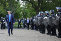U.S. President Trump walks between lines of riot police in Washington