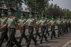 Soldados chinos con mascarillas en los alrededores del mercado de Xinfadi.