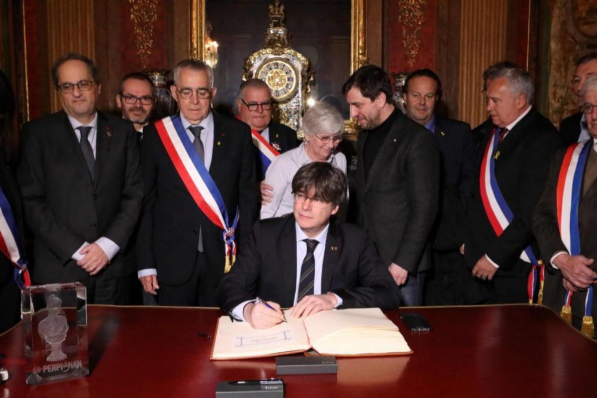 Puigdemont, recibido con honores por el alcalde saliente, Jean-Marc Pujol.