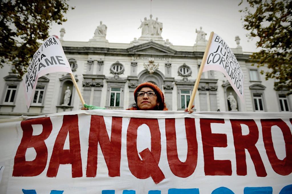 A woman protests before the Supreme Court in Madrid for clues