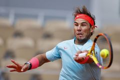 Spain's Rafael lt;HIT gt;Nadal lt;/HIT gt; returns the ball to Sebastian Korda of the US during their men's singles fourth round tennis match on Day 8 of The Roland Garros 2020 French Open tennis tournament in Paris on October 4, 2020. (Photo by Thomas SAMSON / AFP)