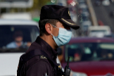 A Spanish National Police officer wearing a protective mask stands at a traffic checkpoint during a partial lockdown amid the outbreak of the coronavirus disease (COVID-19), in lt;HIT gt;Madrid lt;/HIT gt;, Spain October 9, 2020. REUTERS/Juan Medina