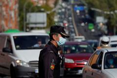 A Spanish National Police officer wearing a protective mask stands at a traffic checkpoint during a partial lockdown amid the outbreak of the coronavirus disease (COVID-19), in lt;HIT gt;Madrid lt;/HIT gt;, Spain October 9, 2020. REUTERS/Juan Medina