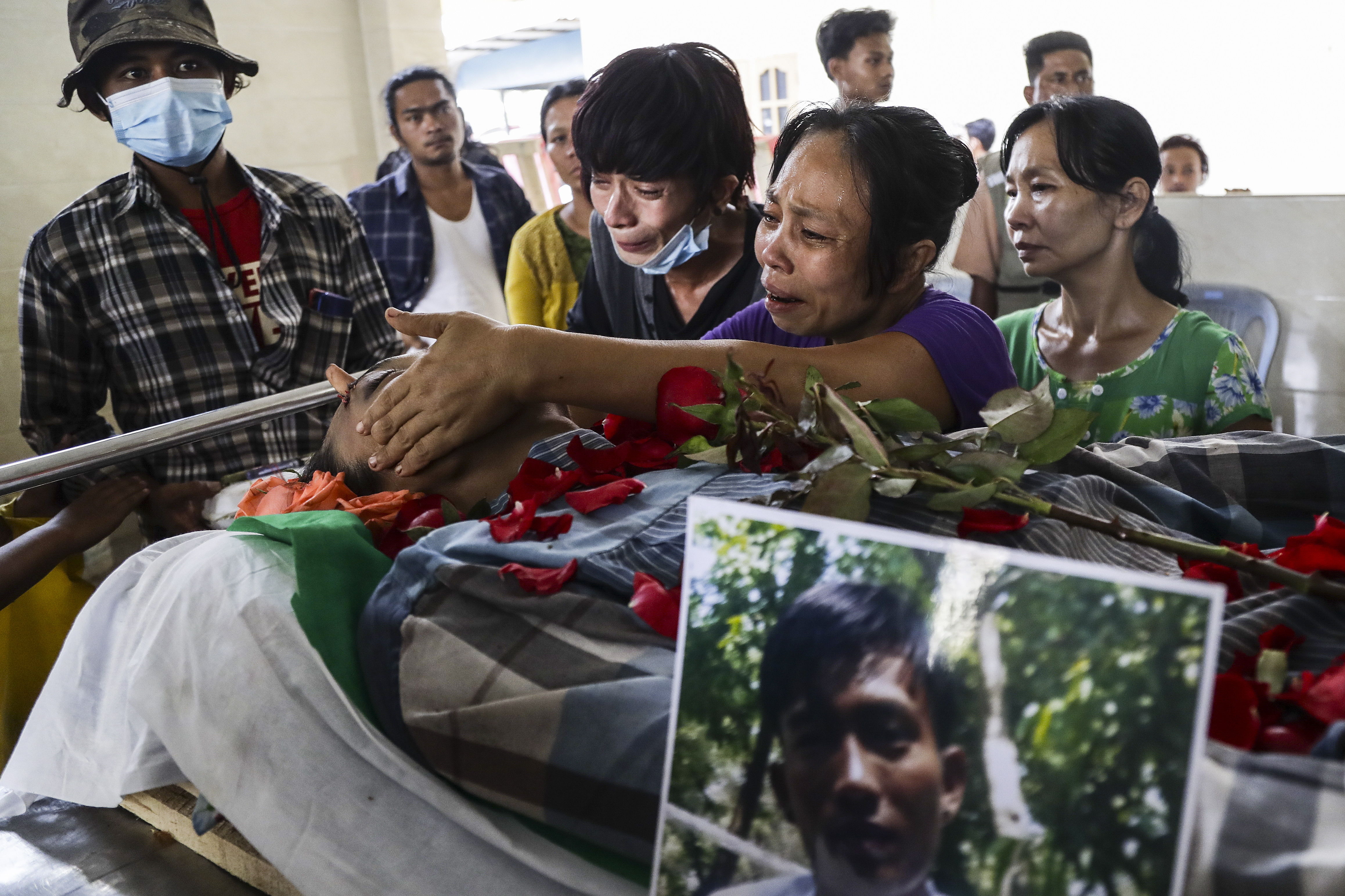 A woman cries at the funeral of her son, killed in protests, in Rang