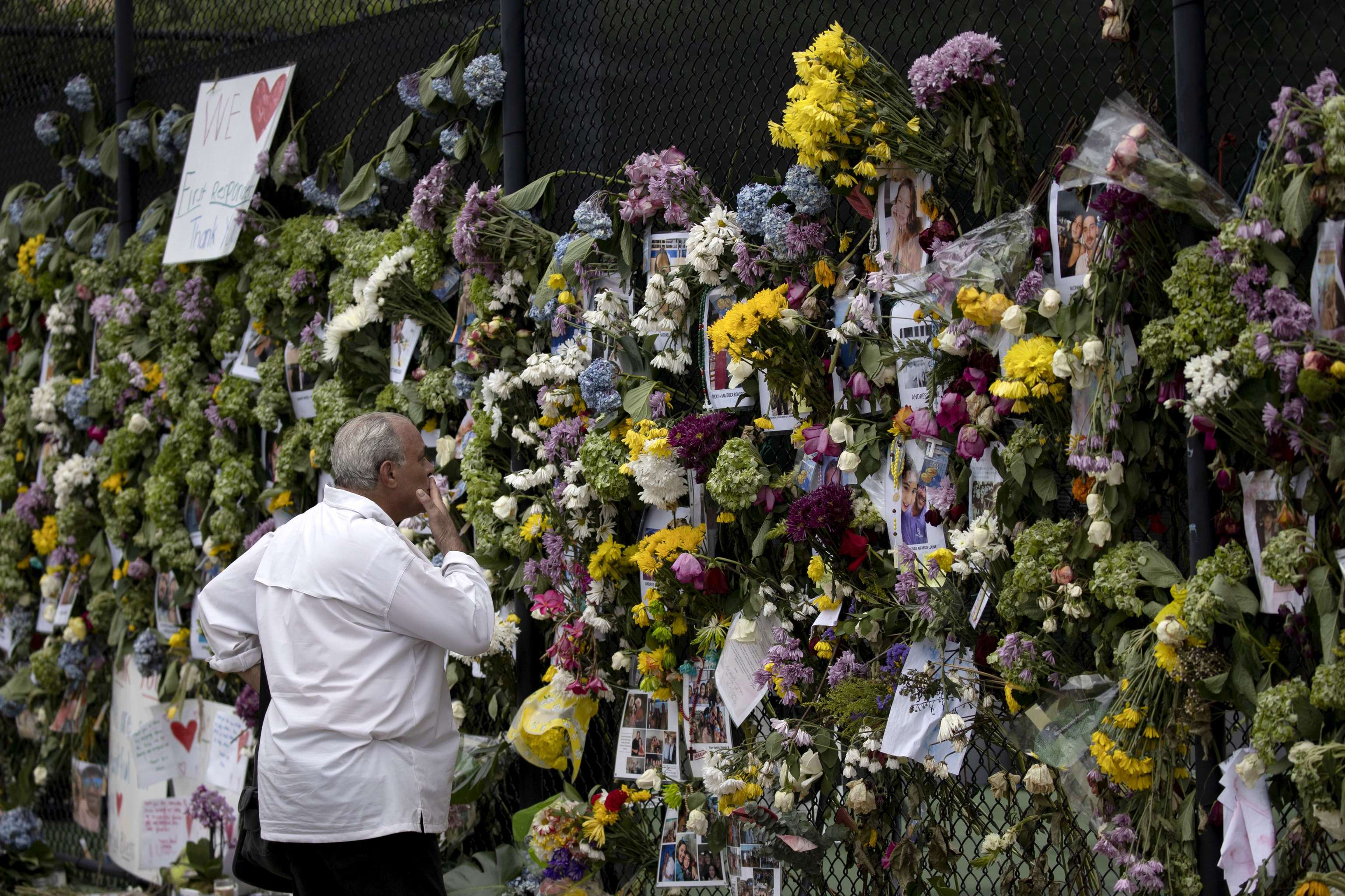Un hombre contempla un memorial con fotografas de algunos de los fallecidos.