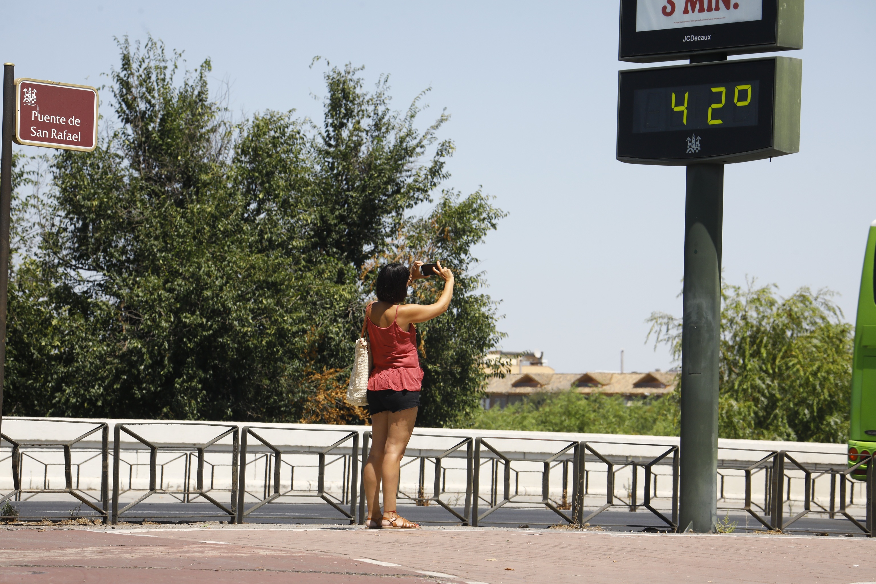 Una mujer fotografa un termmetro de una calle de Crdoba.
