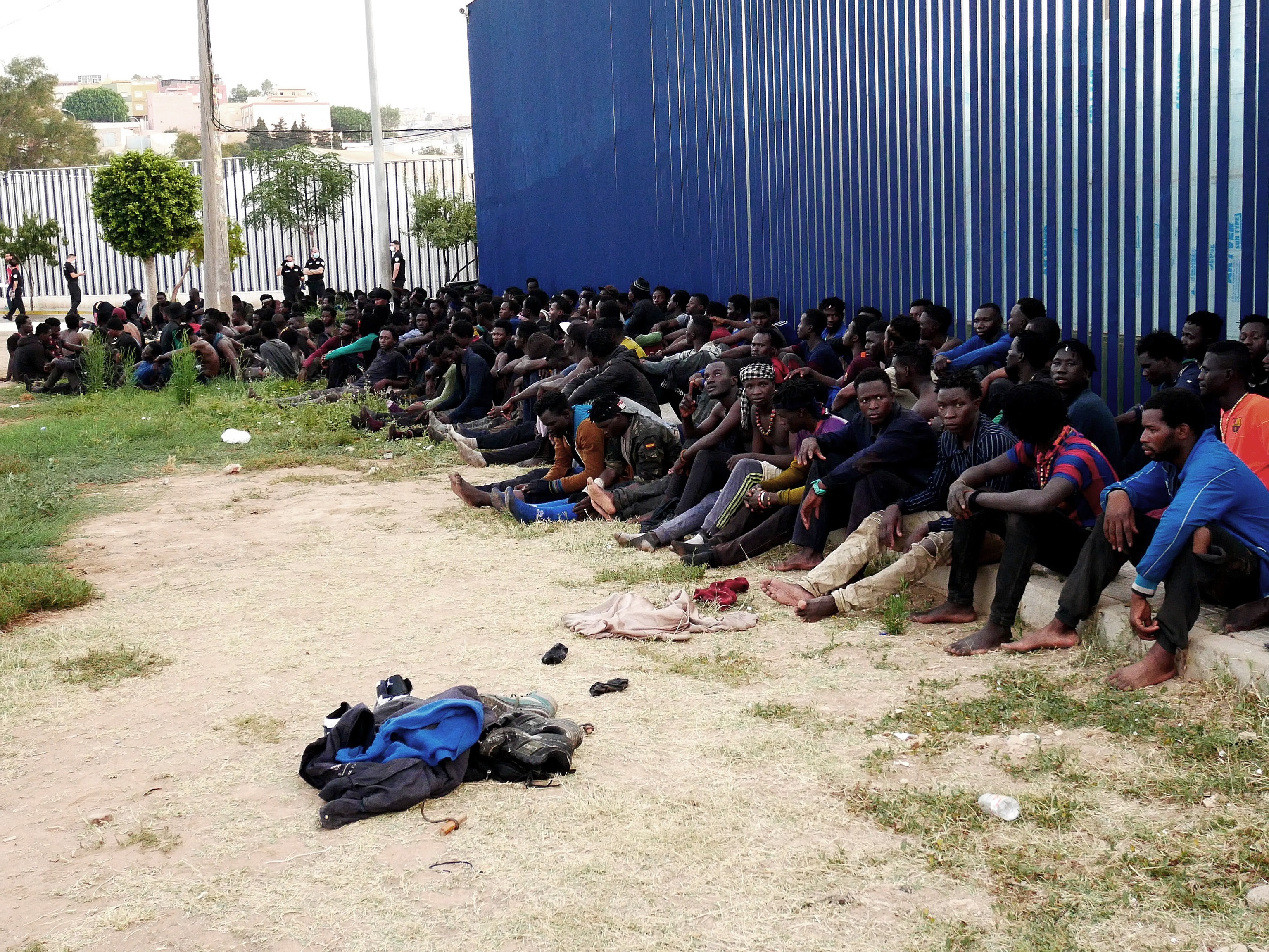 Inmigrantes subsaharianos, tras saltar la valla de Melilla, este jueves.