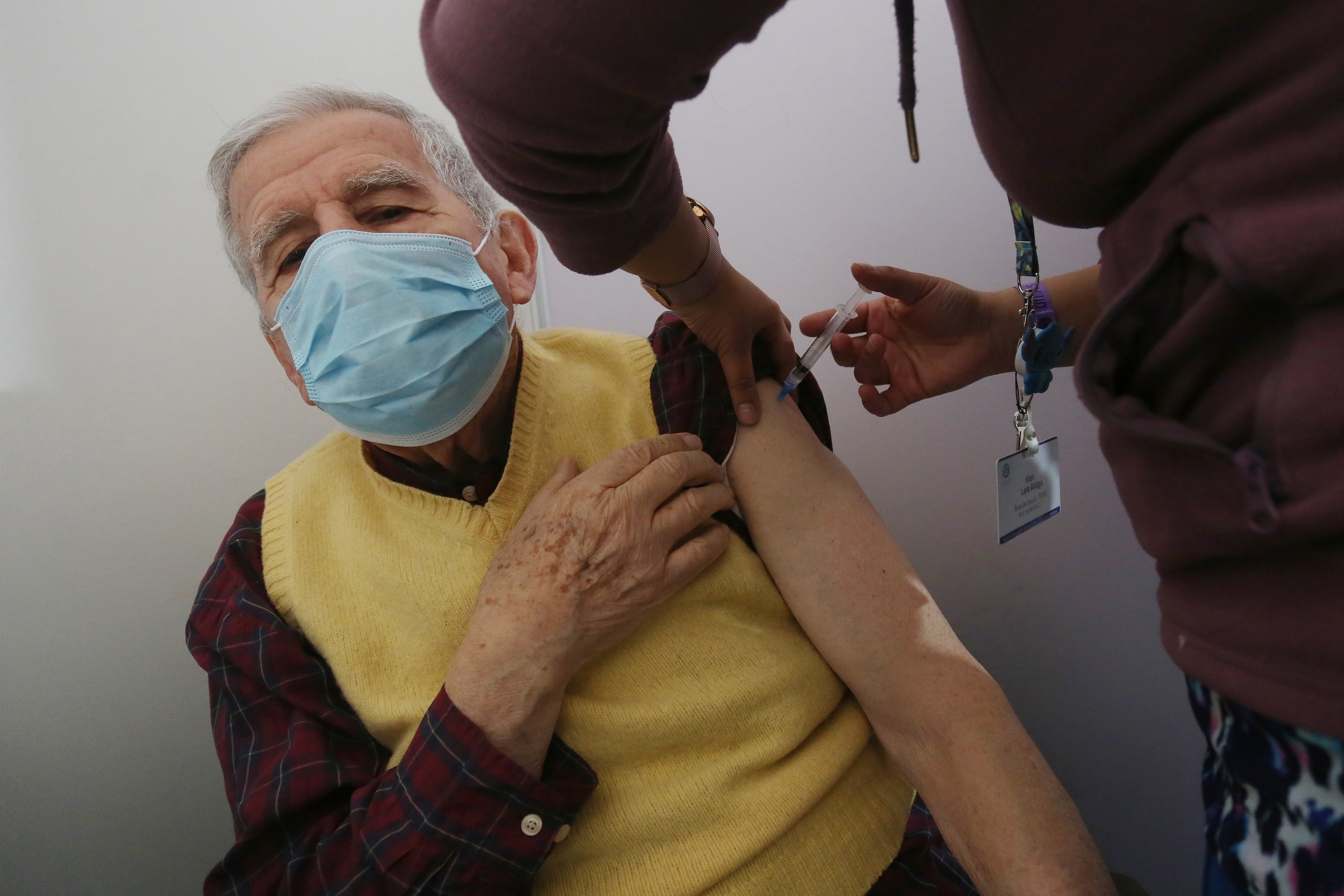 Un adulto mayor recibe una dosis de la vacuna anticovid.