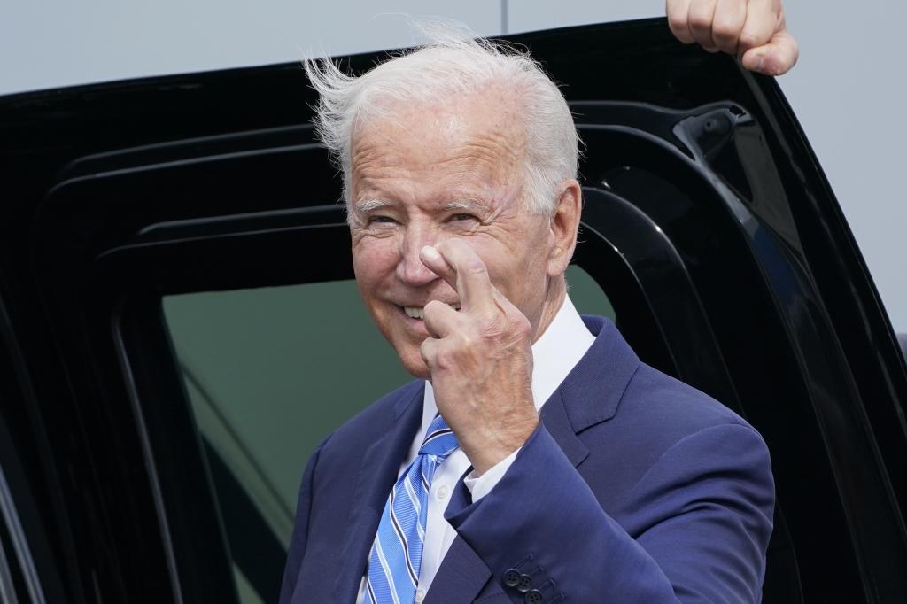 Joe Biden cruza los dedos antes de subir al Air Force One en Chicago.