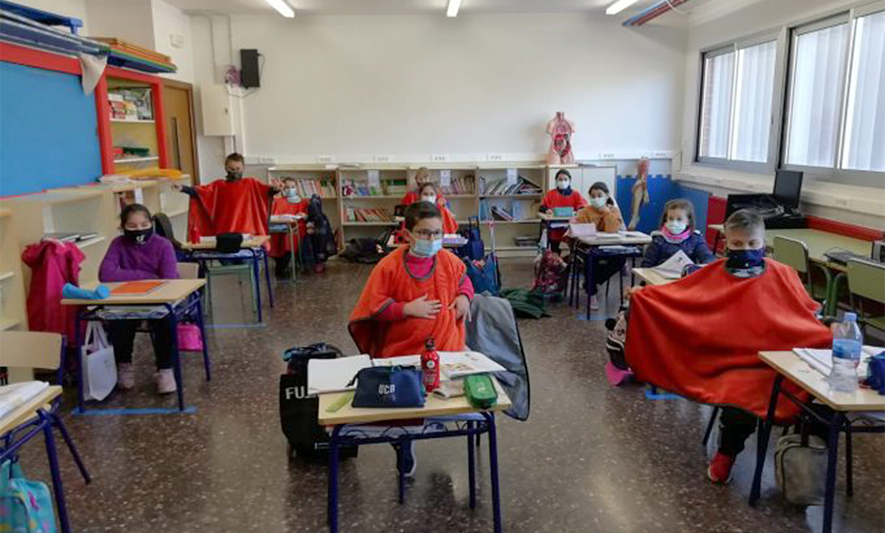 Alumnos de un centro educativo en Nules se protegen con mantas por el fr�o.