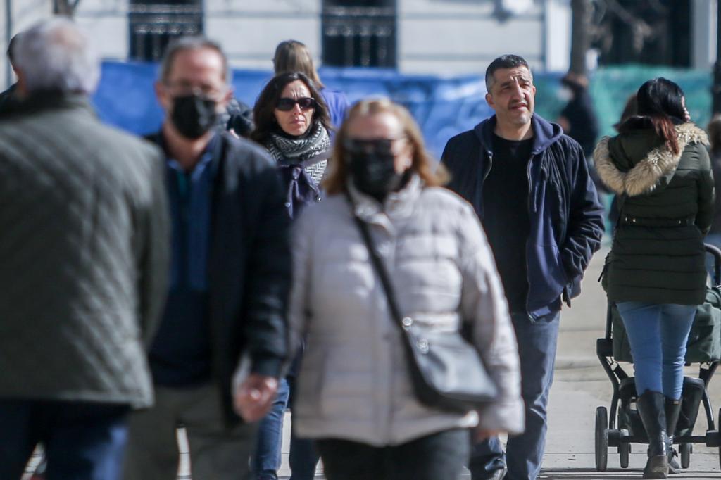 Dos personas caminan sin mascarilla por las calles de Madrid.,
