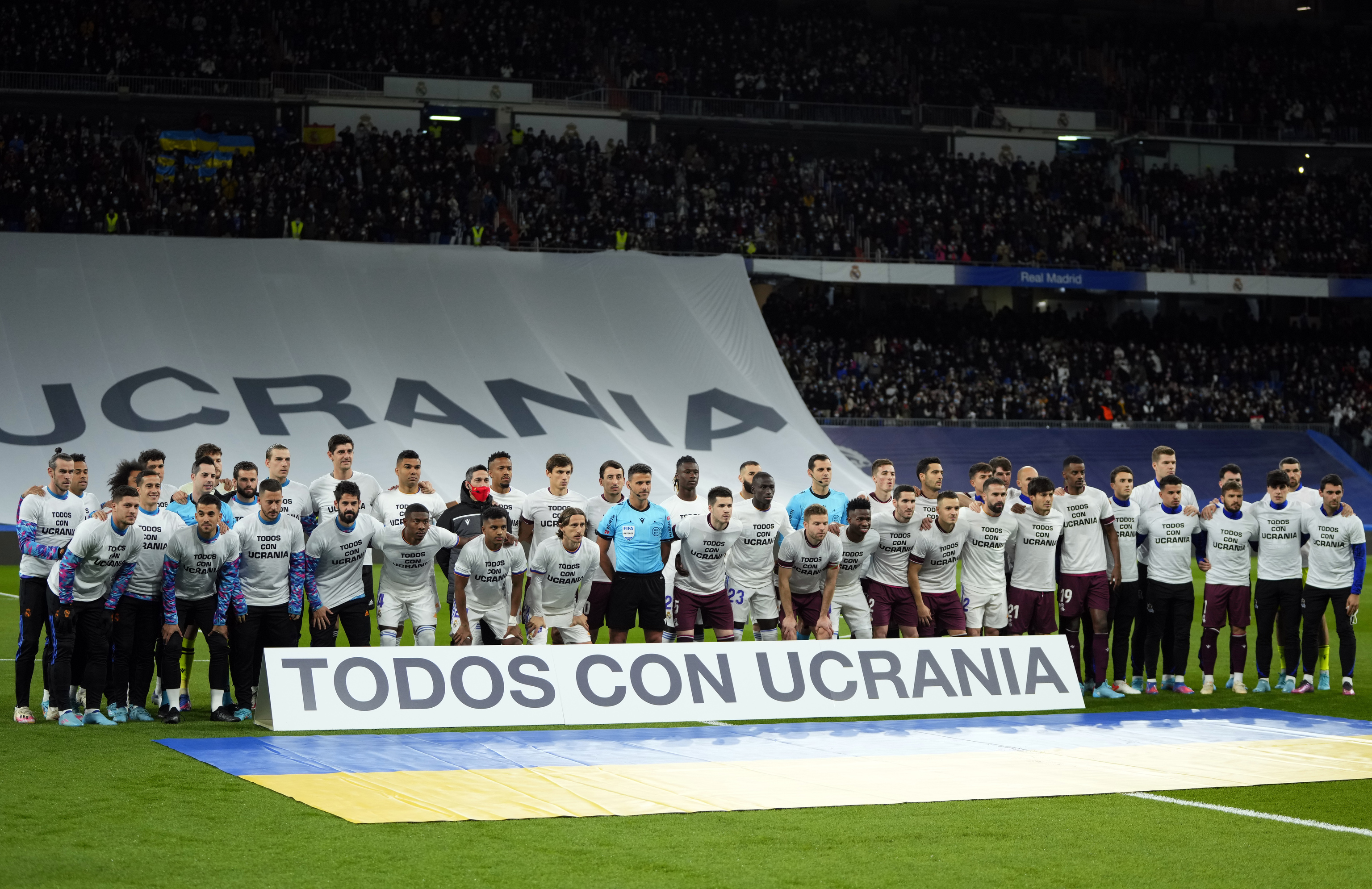 Jugadores del Madrid y la Real, durante el homenaje a Ucrania.
