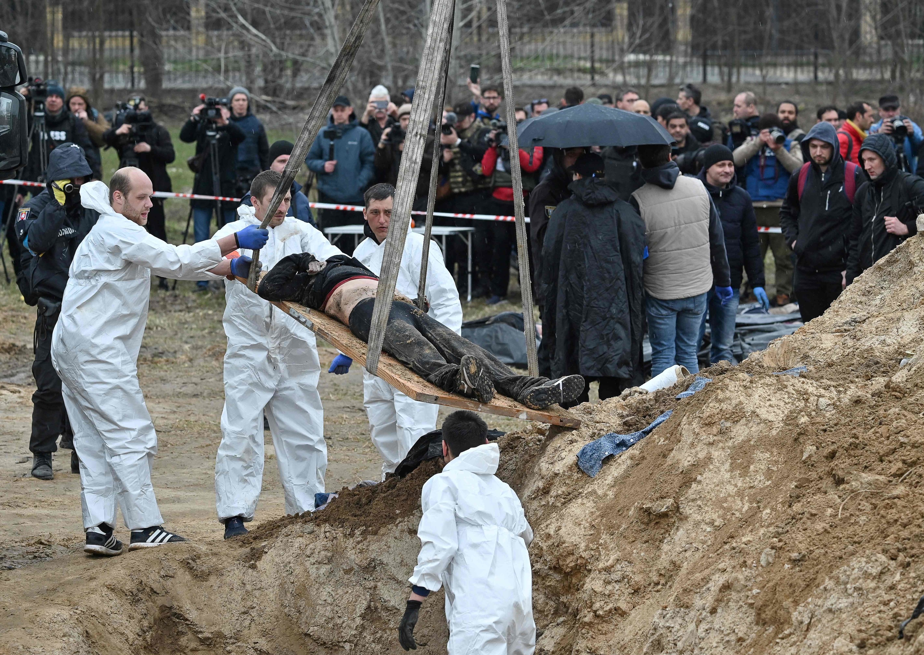 Investigadores ucranianos exhuman cadáveres de una fosa común en Bucha.
