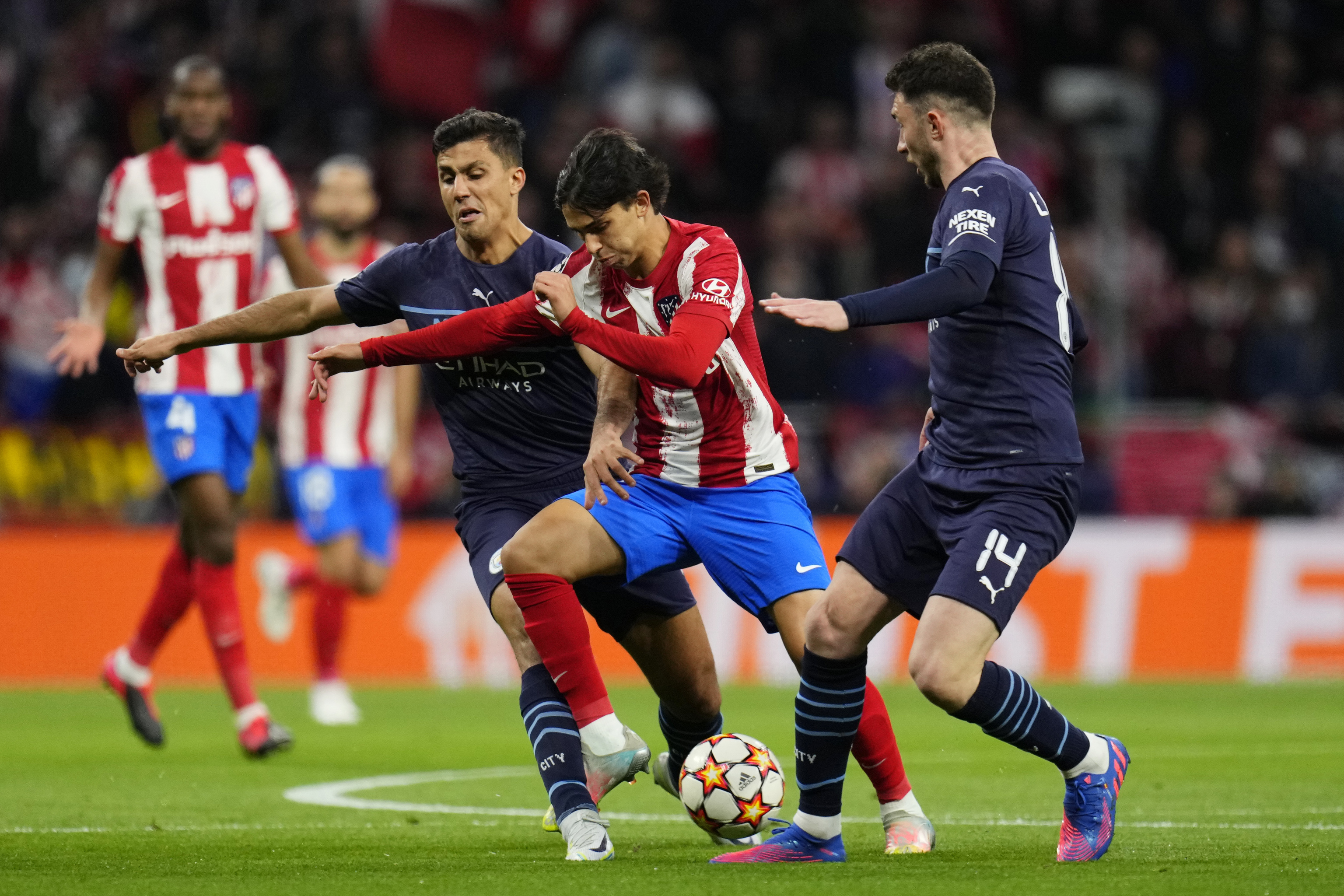 Manchester City's Rodrigo, left, and Manchester City's Aymeric Laporte, right, challenge Atletico Madrid's  lt;HIT gt;Joao lt;/HIT gt;  lt;HIT gt;Felix lt;/HIT gt; during the Champions League quarterfinal second leg soccer match between Atletico Madrid and Manchester City at Wanda Metropolitano stadium in Madrid, Spain, Wednesday, April 13, 2022. (AP Photo/Manu Fernandez)