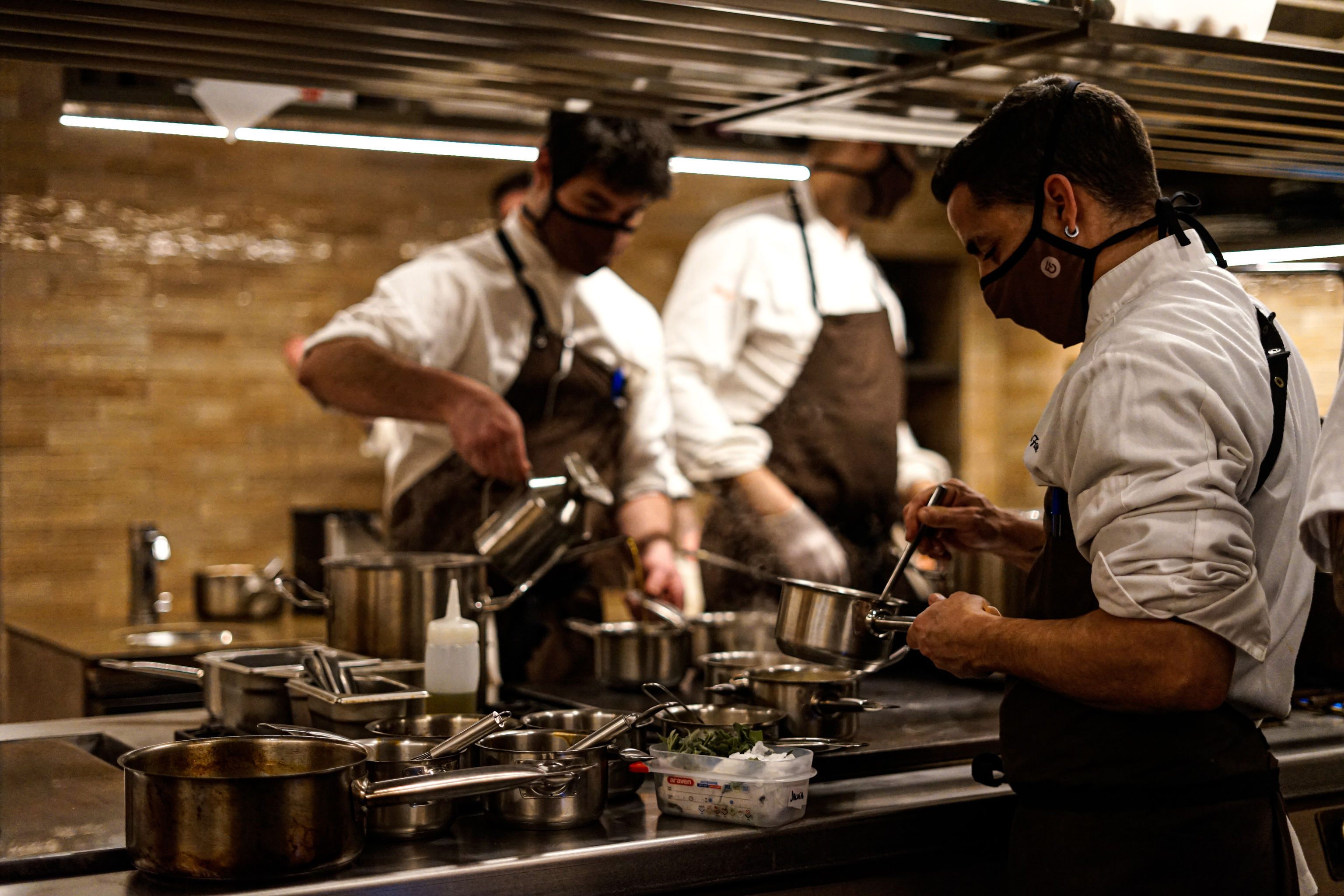 The kitchen, where you can see the team working, is the backbone of the space.