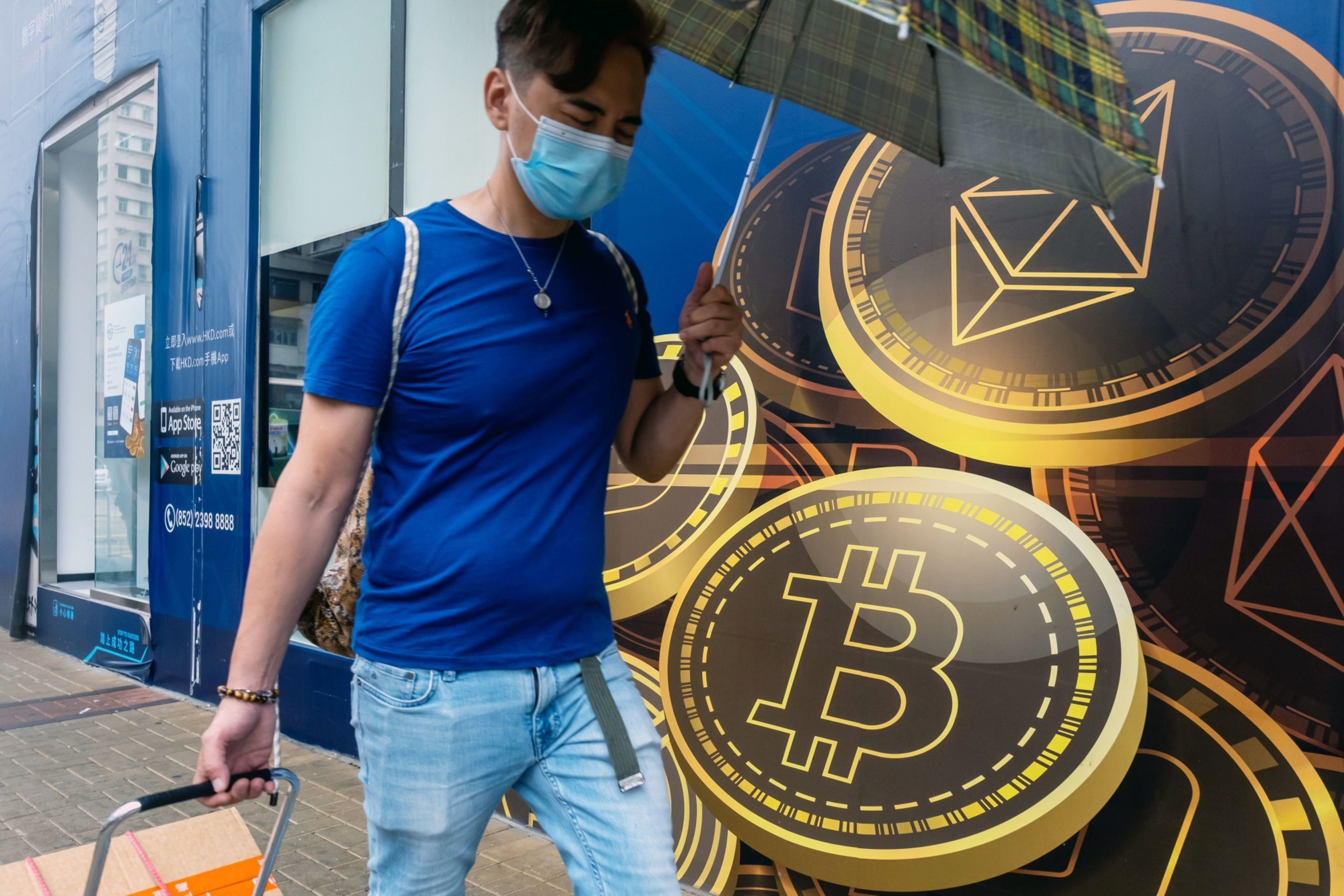 A man walks past a crypto store.