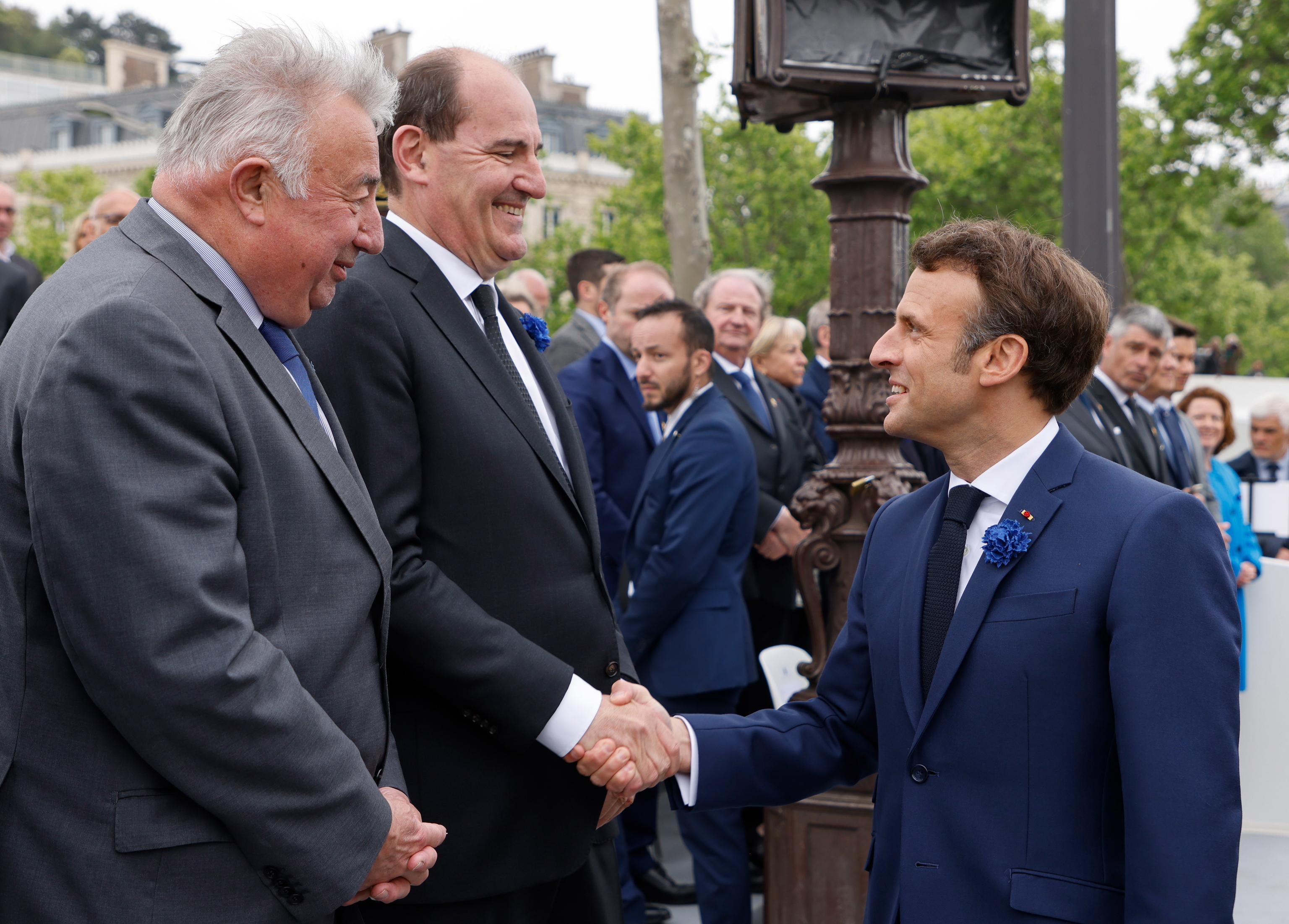 On the right, French President Emmanuel Macron congratulates Prime Minister Jean Casteux, on the left