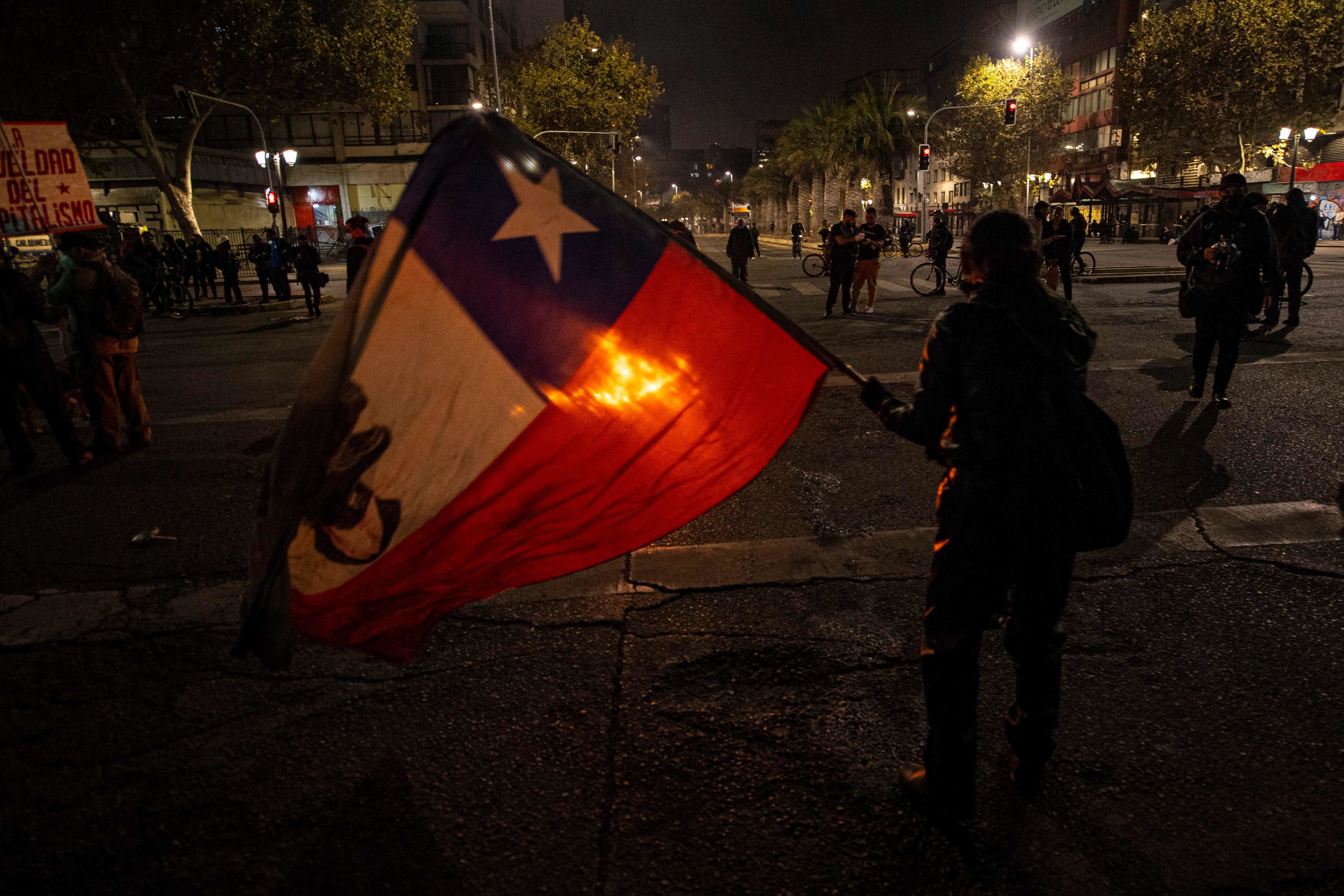 A man waving the Chilean flag in Santiago.