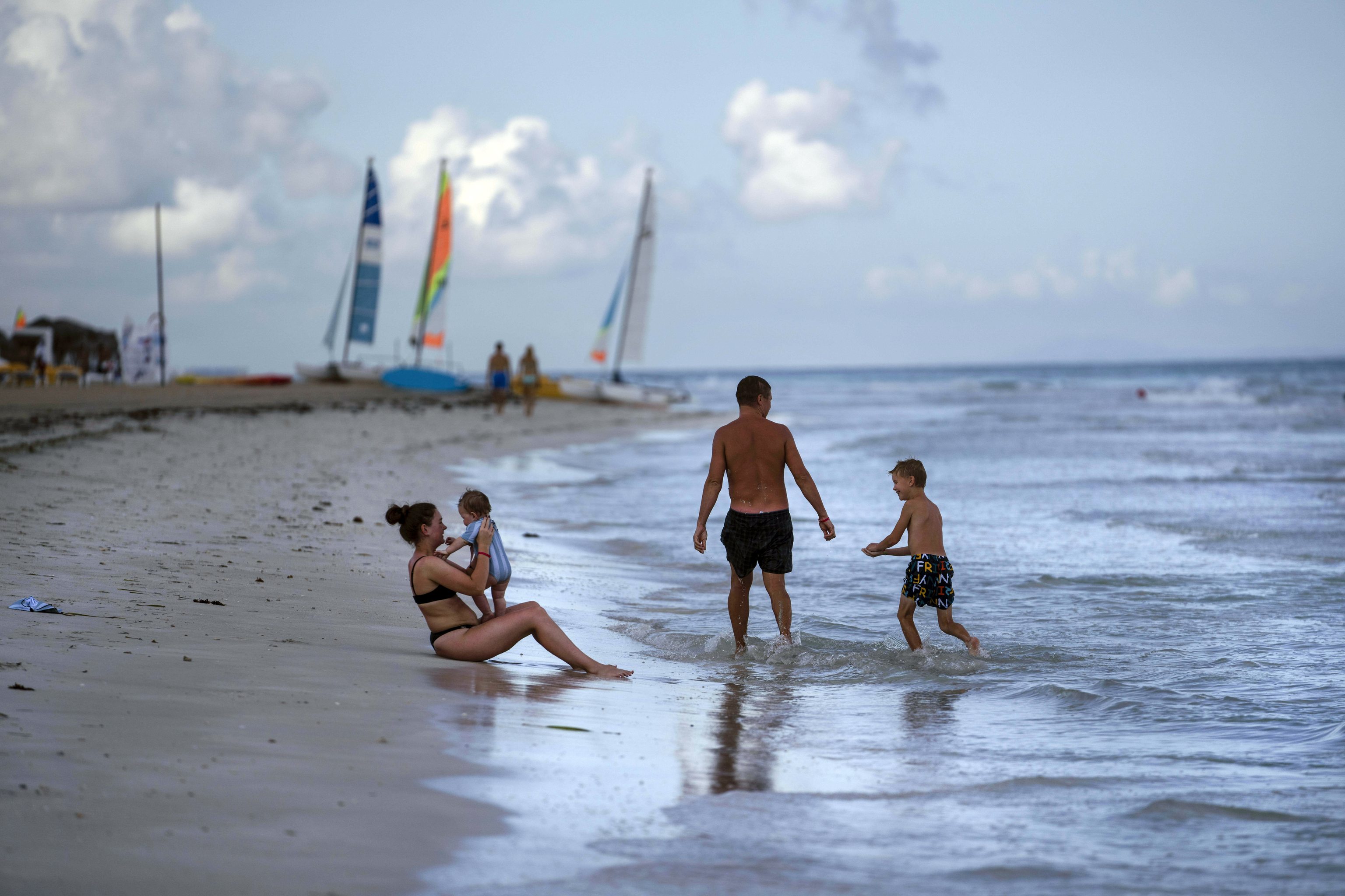 A family of tourists enjoy the beach in Varadero, Cuba.