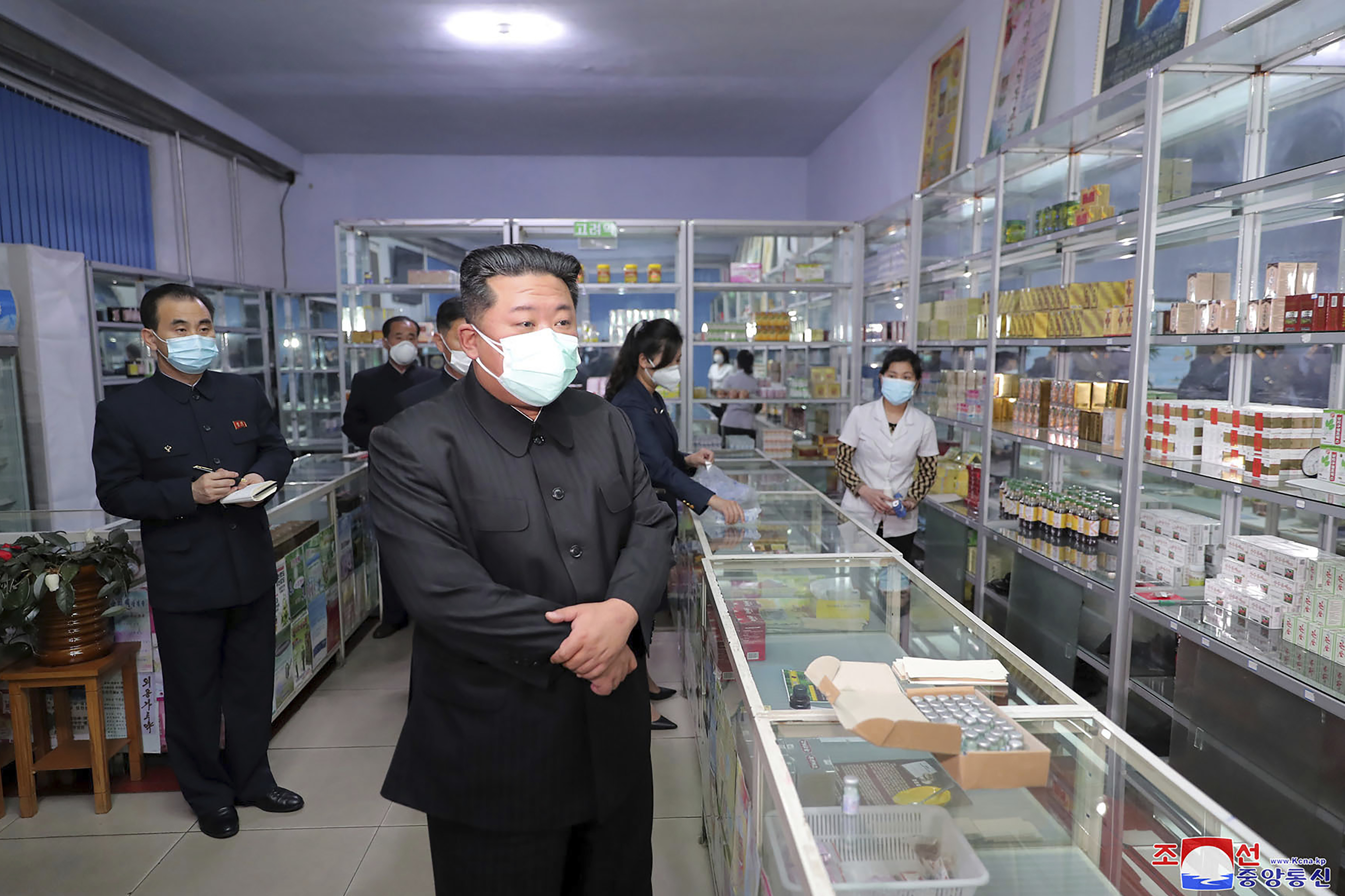 Kim Jong-un wearing a mask at a pharmacy in Pyongyang.