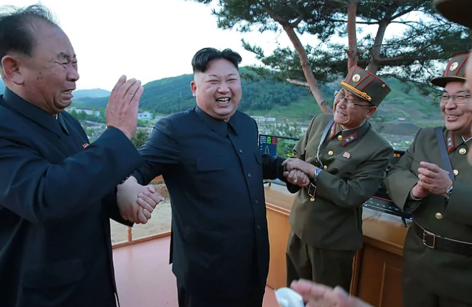 Kim Jong-un celebrates a successful missile launch.