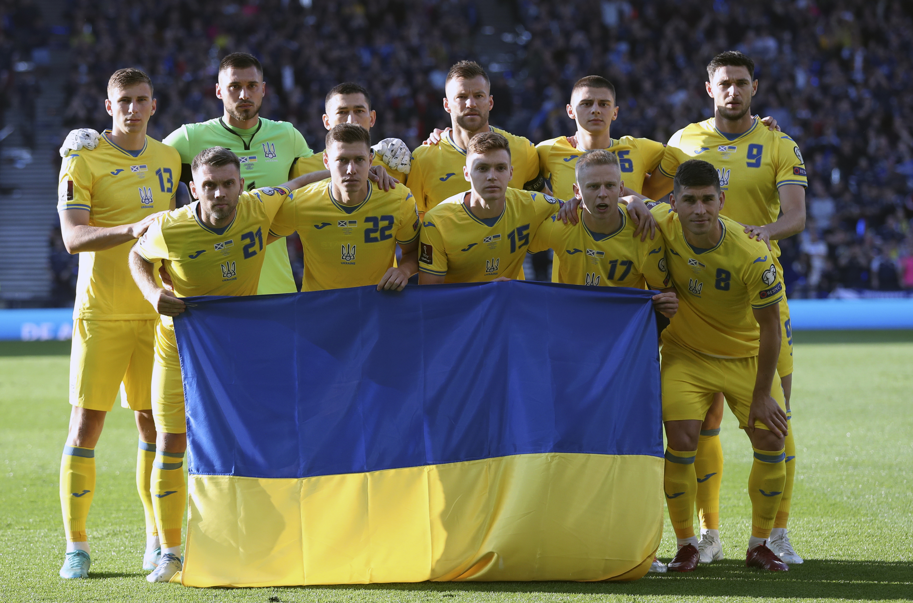 Ukrainian football players posing with flags.