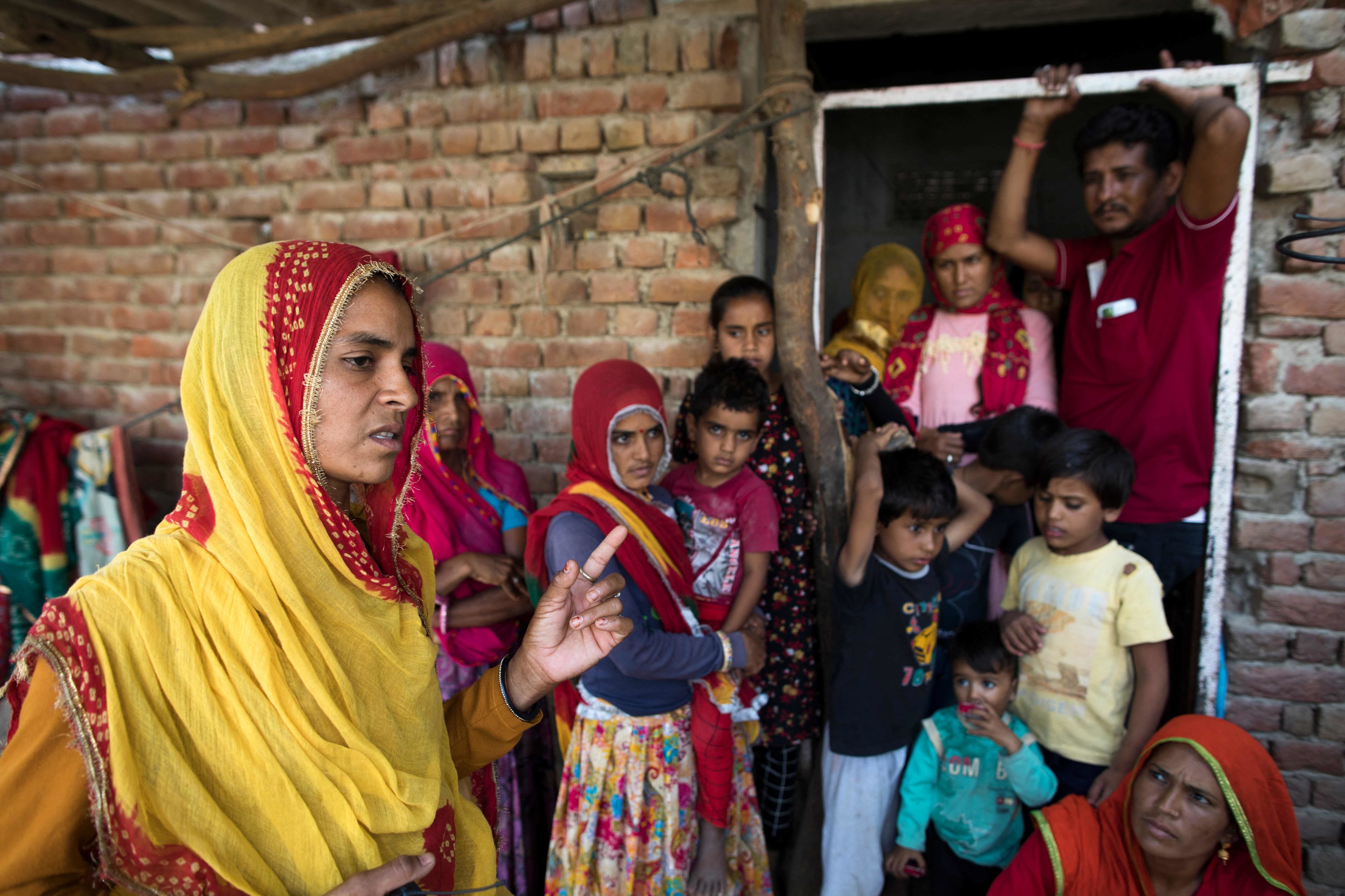 Sonu (L), the elder sister of three married women who were found dead along with their two children in a well in Dudu village on May 28, speaks during an interview with AFP at the family home in Chhapya village in India.  Rajasthani State