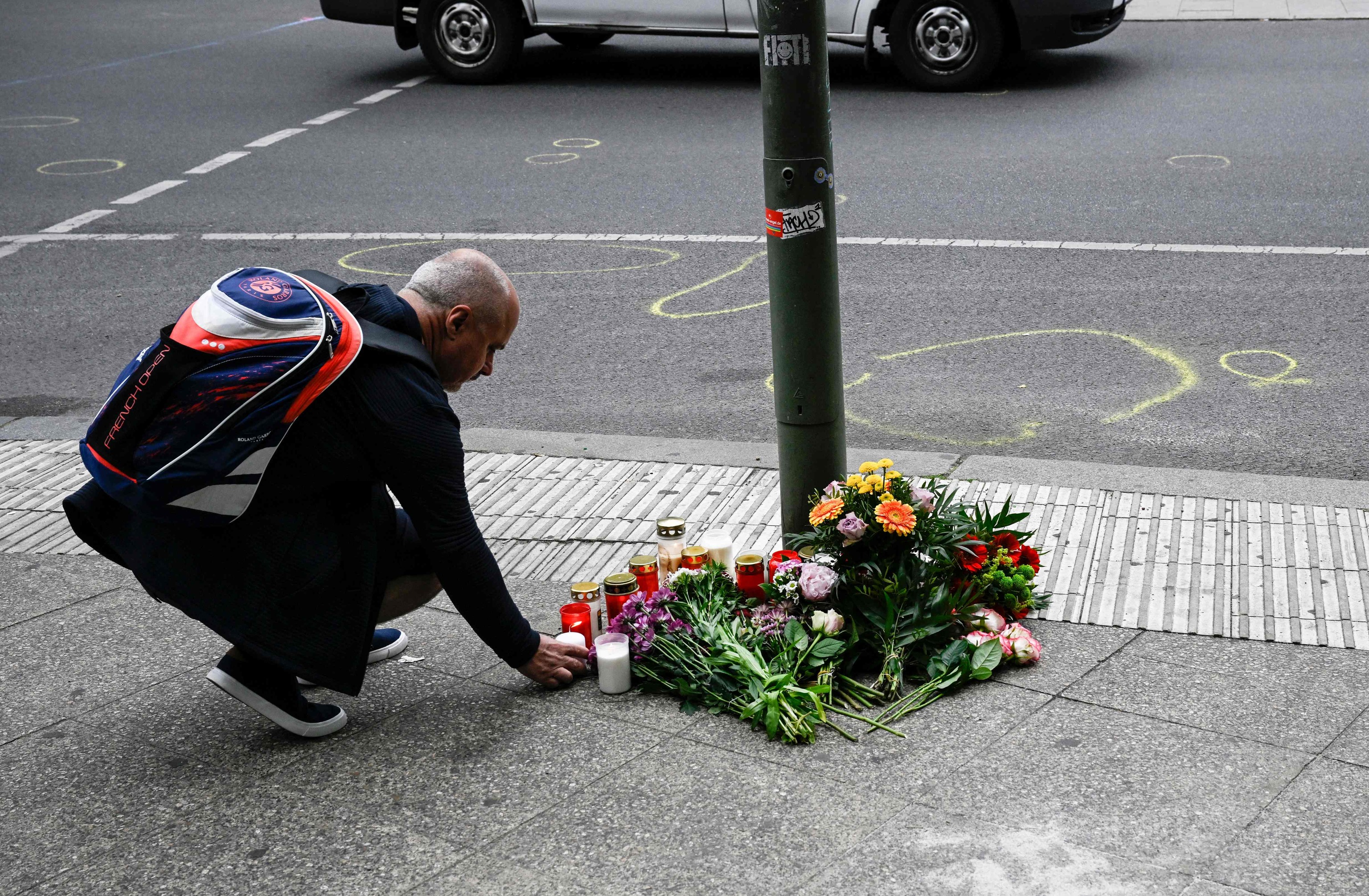 A man leaves flowers at the crash site in Berlin.