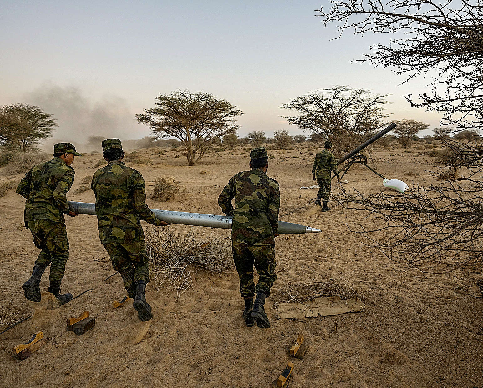 Three Polisario Front soldiers carry a rocket during the attack on Morocco, near Mahares, S