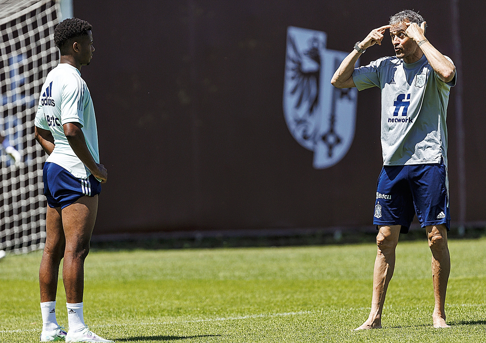 Luis Enrique talks with Anu Fati during training.