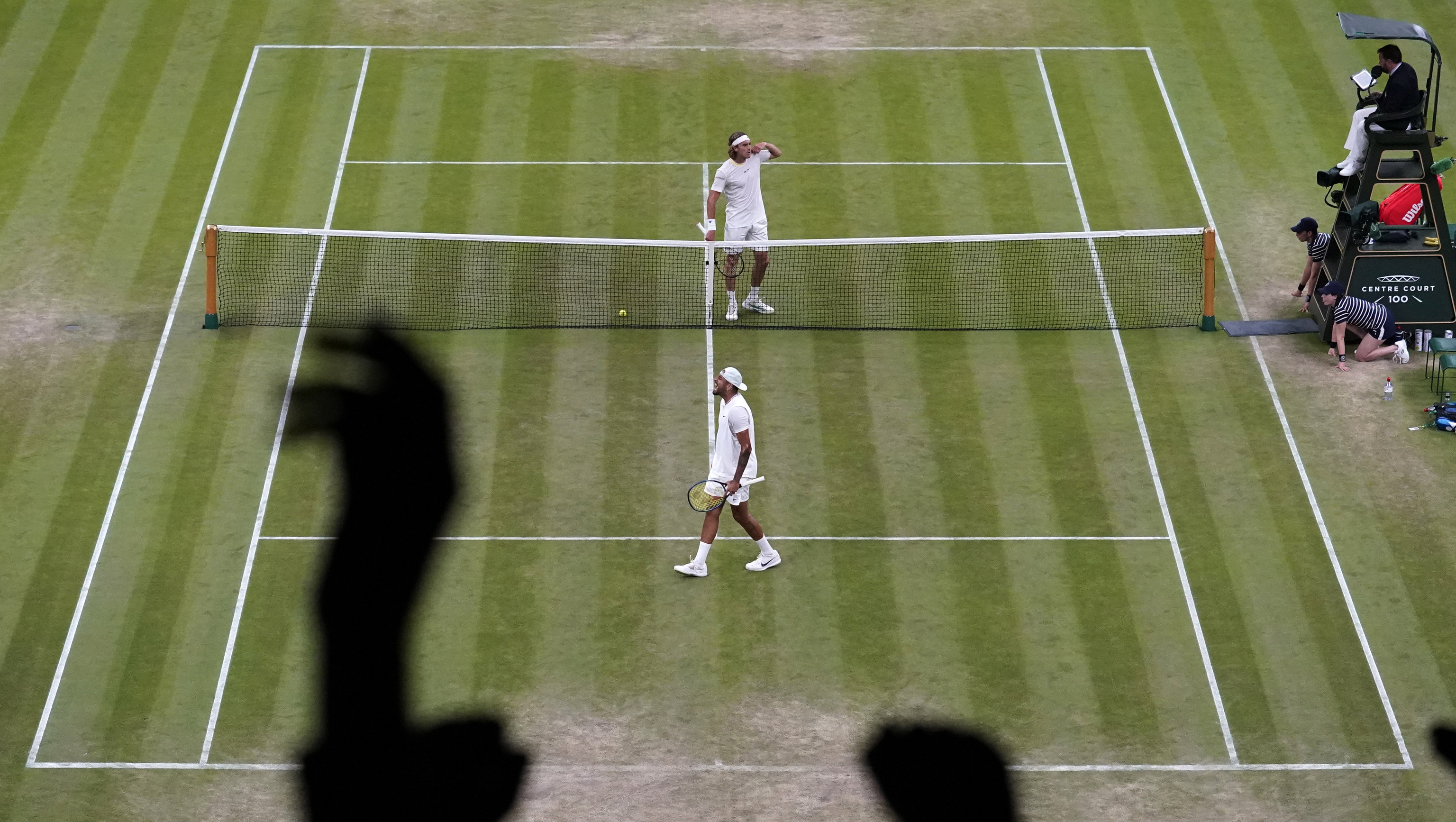 Kyrgios, below, and Sitsipas, above, during their match.
