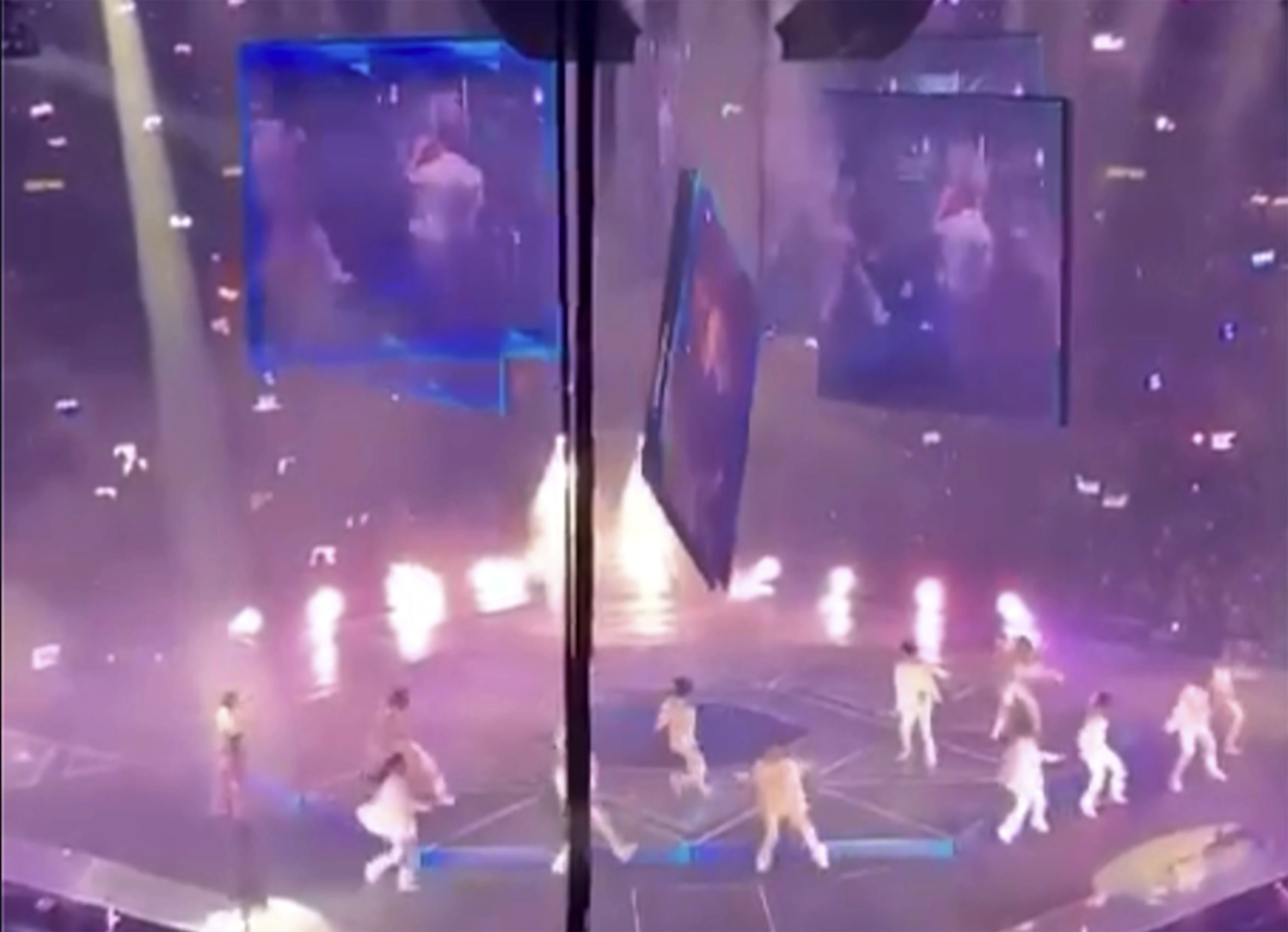 Una enorme pantalla de vdeo suspendida sobre el escenario cae sobre los artistas en un concierto de la banda Mirror.