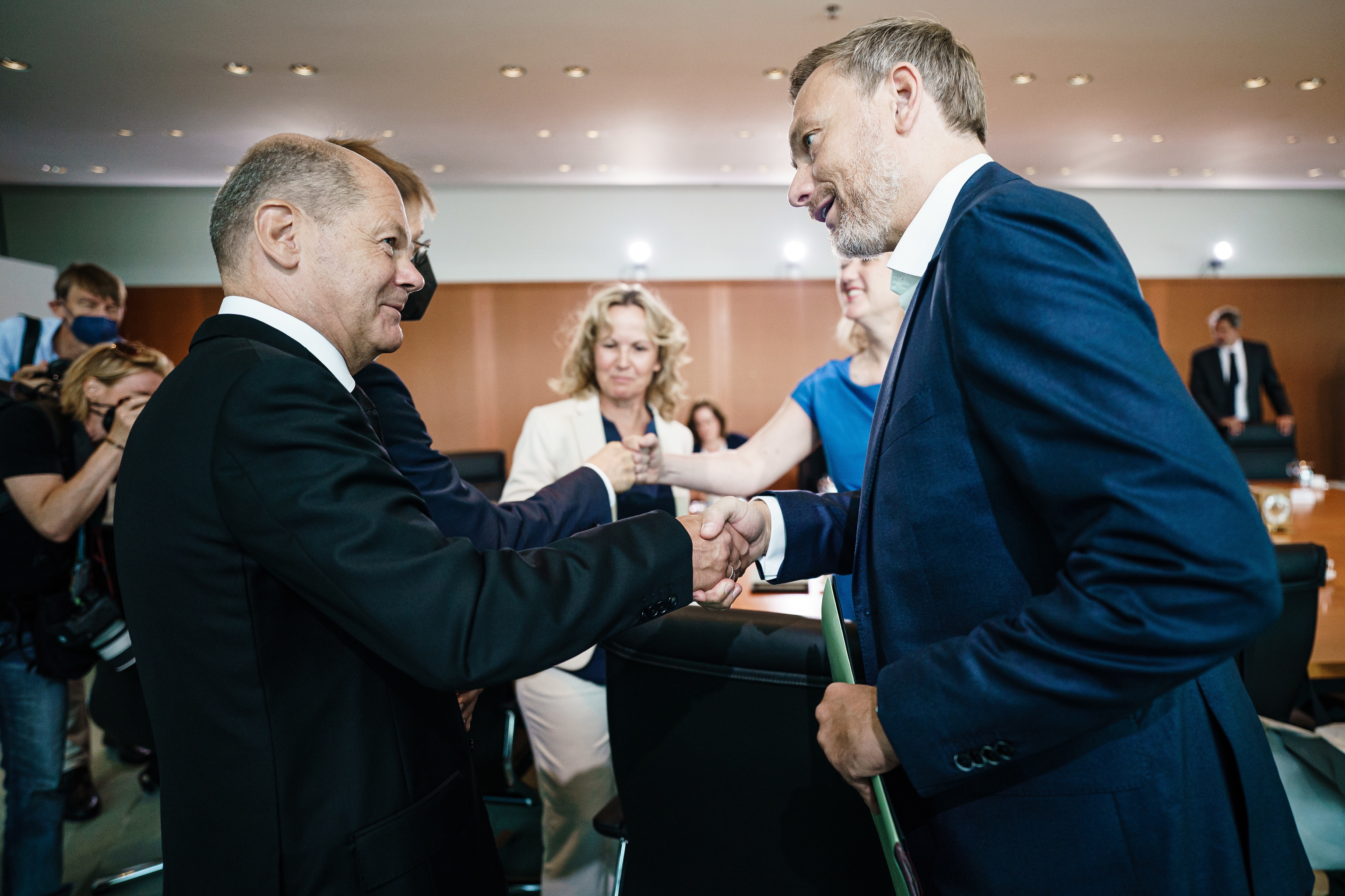 El canciller Olaf Scholz y el ministro de economía Christian Lindnerse dan la mano en la reunión semanal del gabinete federal alemán