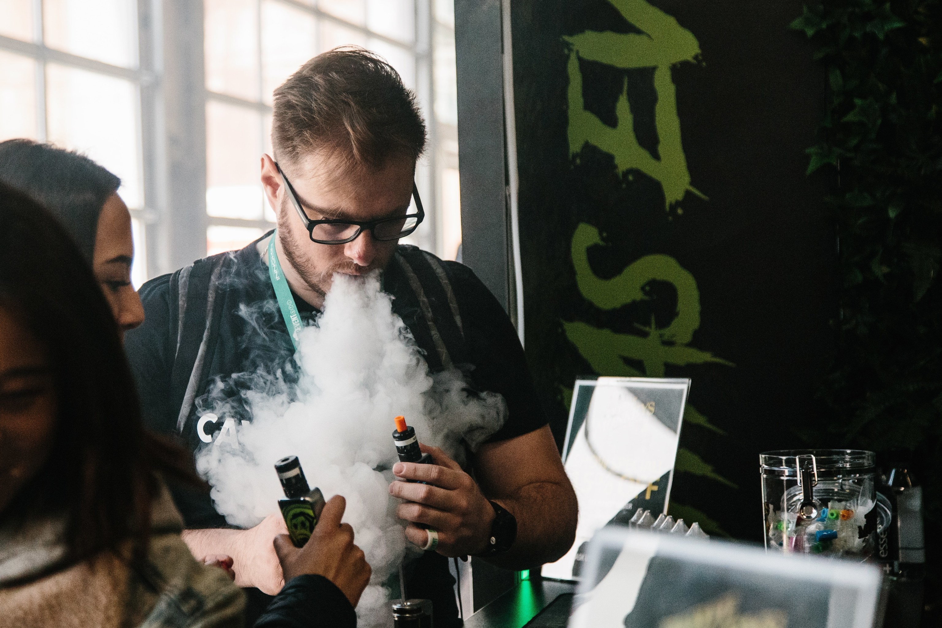 Un hombre expulsa vapor por la boca durante la tercera edición de "Vapevent Trade Show", una feria comercial que recoge las últimas tendencias de vapeo. ALBA VIGARAY EFE