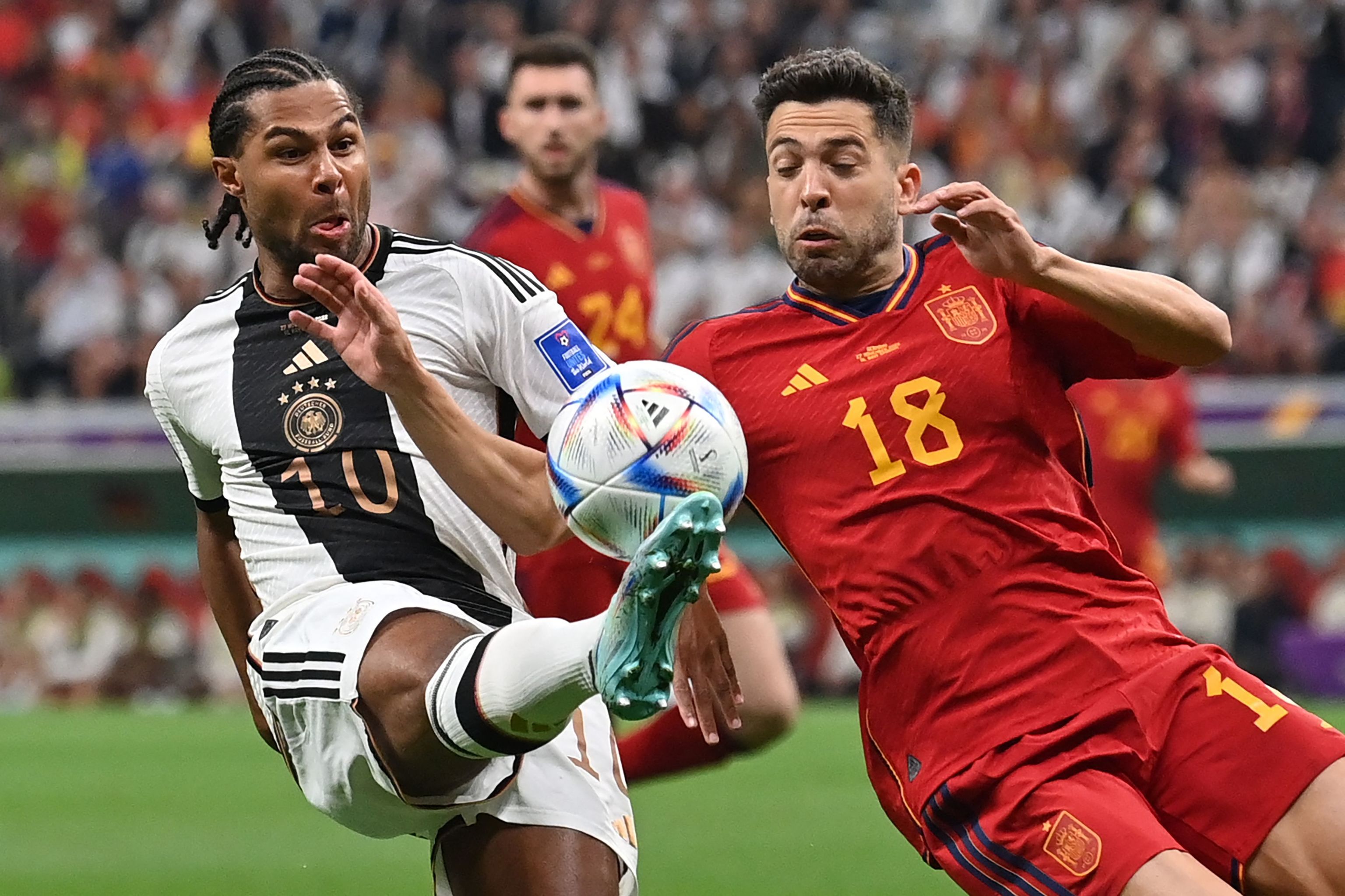 Germany's forward #10 Serge Gnabry vies with  lt;HIT gt;Spain lt;/HIT gt;'s defender #18 Jordi Alba during the Qatar 2022 World Cup Group E football match between  lt;HIT gt;Spain lt;/HIT gt; and Germany at the Al-Bayt Stadium in Al Khor, north of Doha on November 27, 2022. (Photo by Glyn KIRK / AFP)