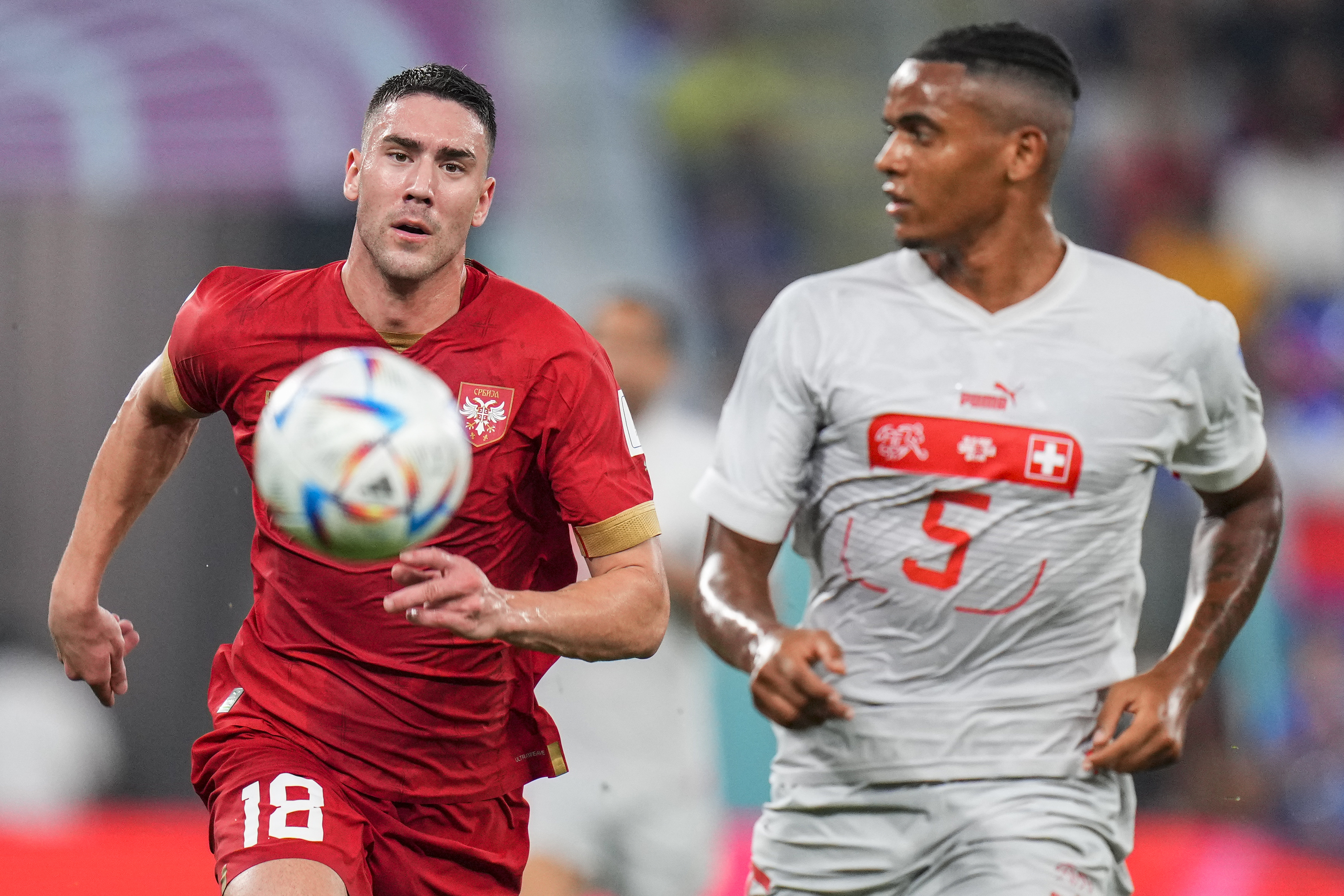 Serbia's Dusan Vlahovic, left, vies for the ball with  lt;HIT gt;Switzerland lt;/HIT gt;'s Manuel Akanji during the World Cup group G soccer match between Serbia and  lt;HIT gt;Switzerland lt;/HIT gt;, at the Stadium 974 in Doha, Qatar, Friday, Dec. 2, 2022. (AP Photo/Petr David Josek)