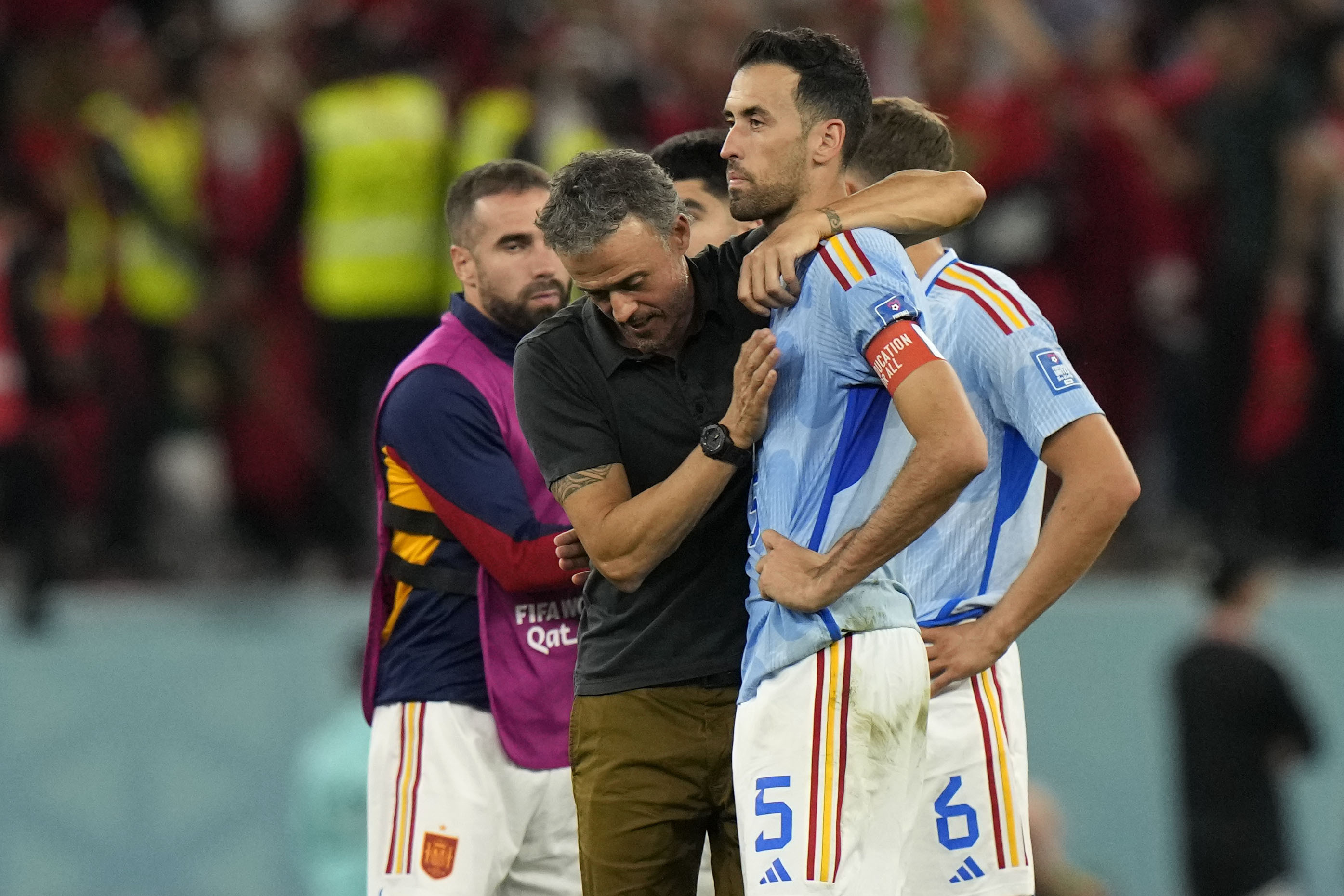 Spain's head coach Luis  lt;HIT gt;Enrique lt;/HIT gt;, left, embraces Sergio Busquets after the penalty shootout at the World Cup round of 16 soccer match between Morocco and Spain, at the Education City Stadium in Al Rayyan, Qatar, Tuesday, Dec. 6, 2022. (AP Photo/Luca Bruno)