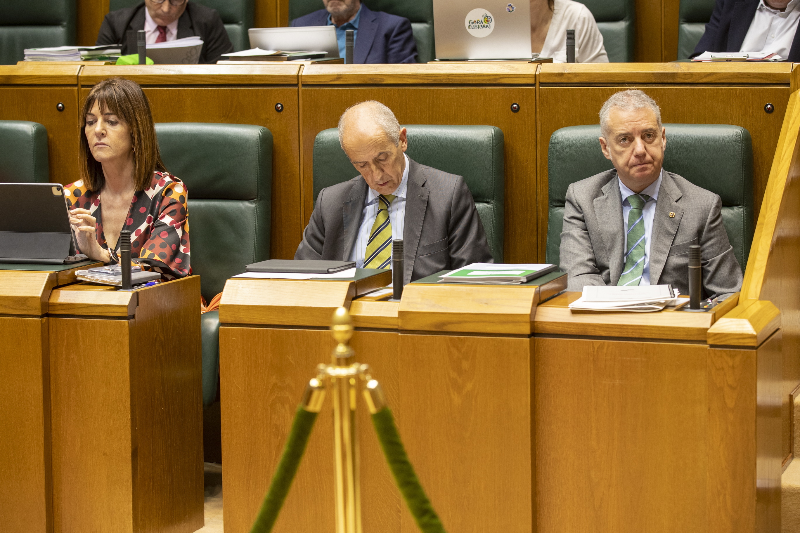 El lehendakari Urkullu sigue el debate mientras los vicelehendakaris Erkoreka y Mendia atienden a sus dispositivos mviles en el pleno del Parlamento Vasco.