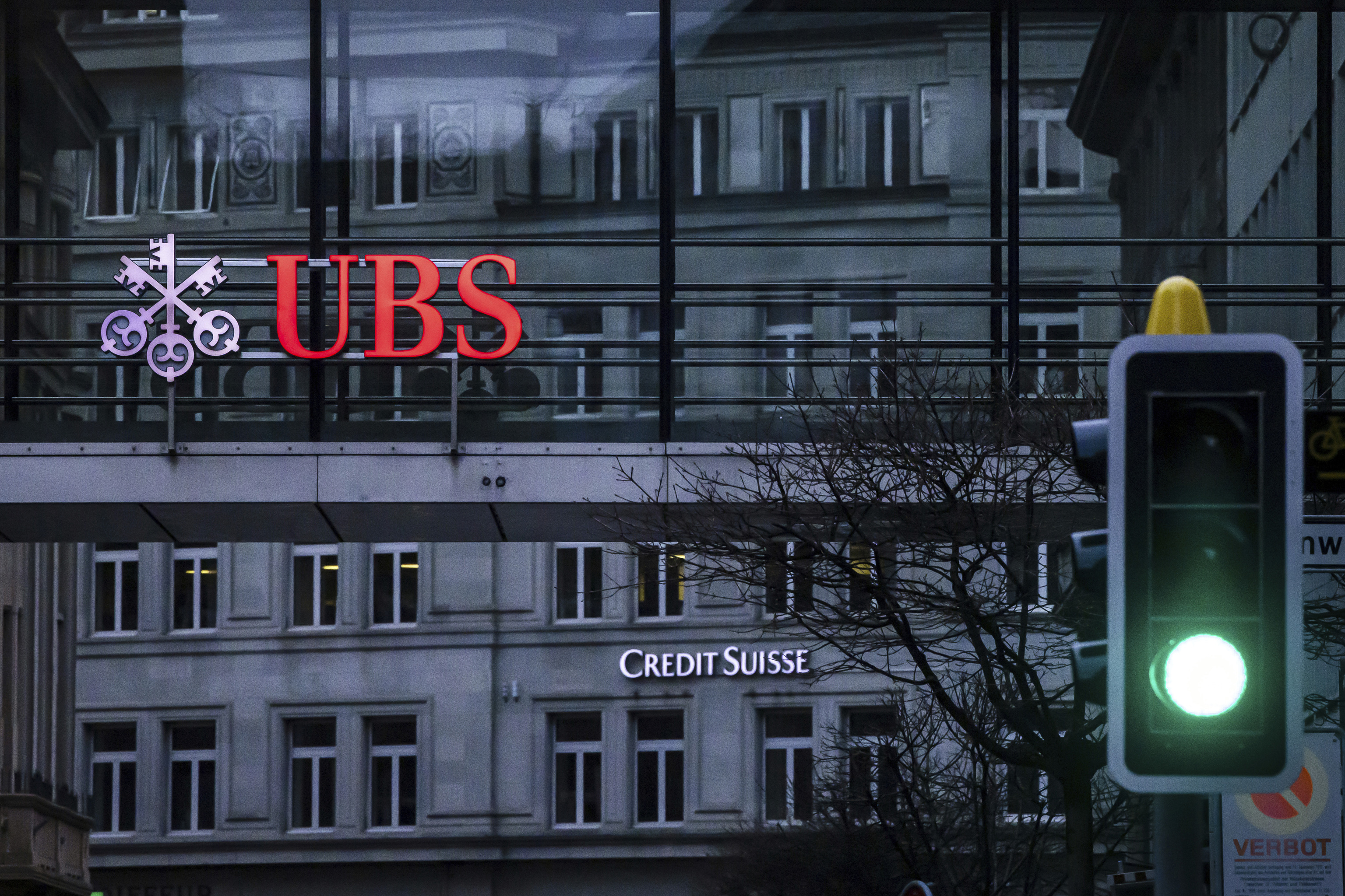 Un semforo ante los carteles de las sedes de UBS y Credit Suisse en Zrich.