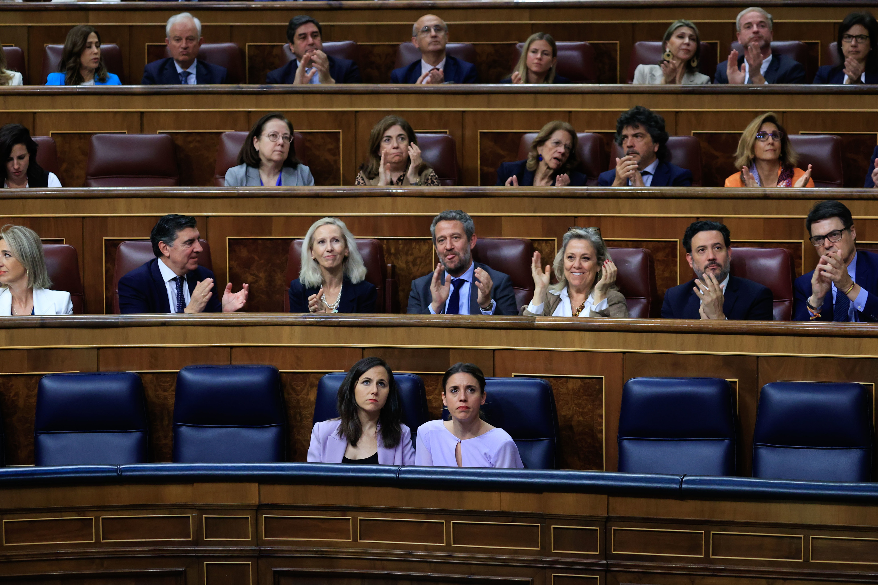Diputados del PP aplauden tras la votacin, con las ministras Belarra y Montero con rostro serio.