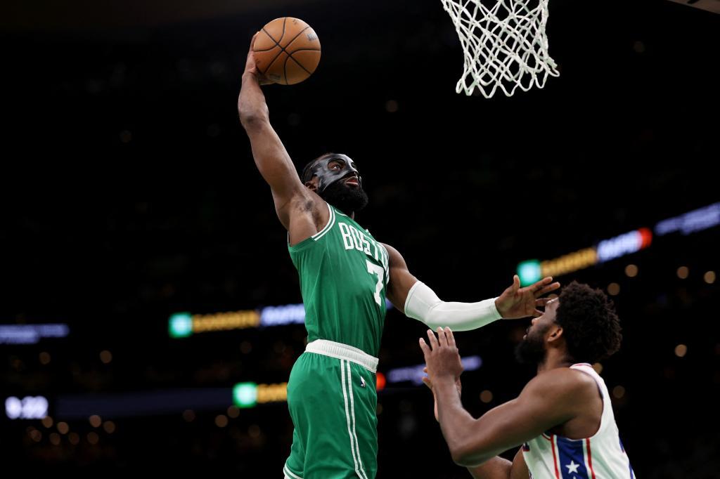Jaylen Brown #7 de los Boston Celtics clava el balón sobre Joel Embiid #21 de los Philadelphia 76ers.