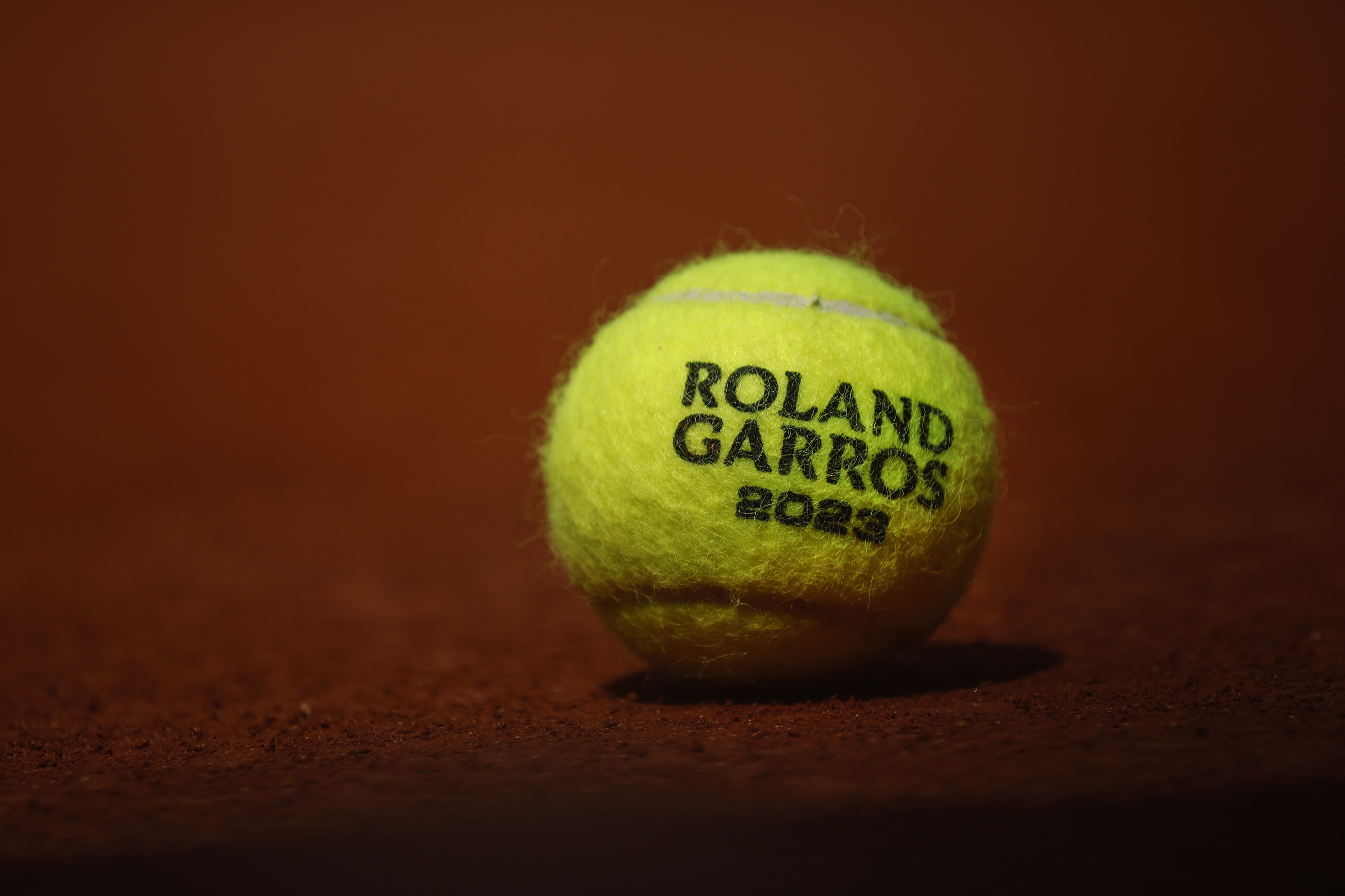 Una pelota de tenis de Roland Garros 2023, sobre la tierra batida de una de las pistas del Stade Roland-Garros de Pars.