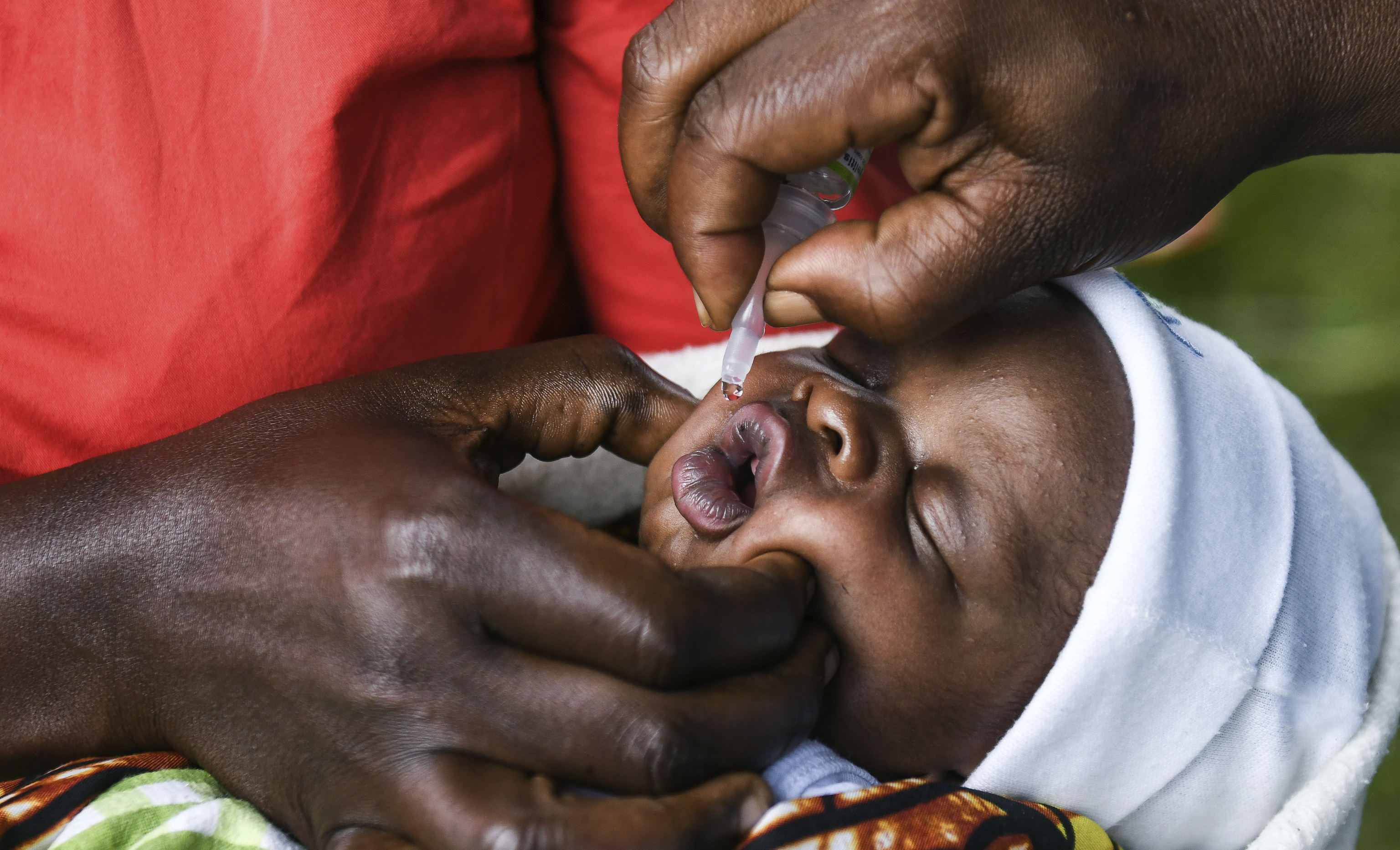 A baby receives a dose of the oral polio vaccine during the vaccination campaign against the infection in Malawi in 2020.