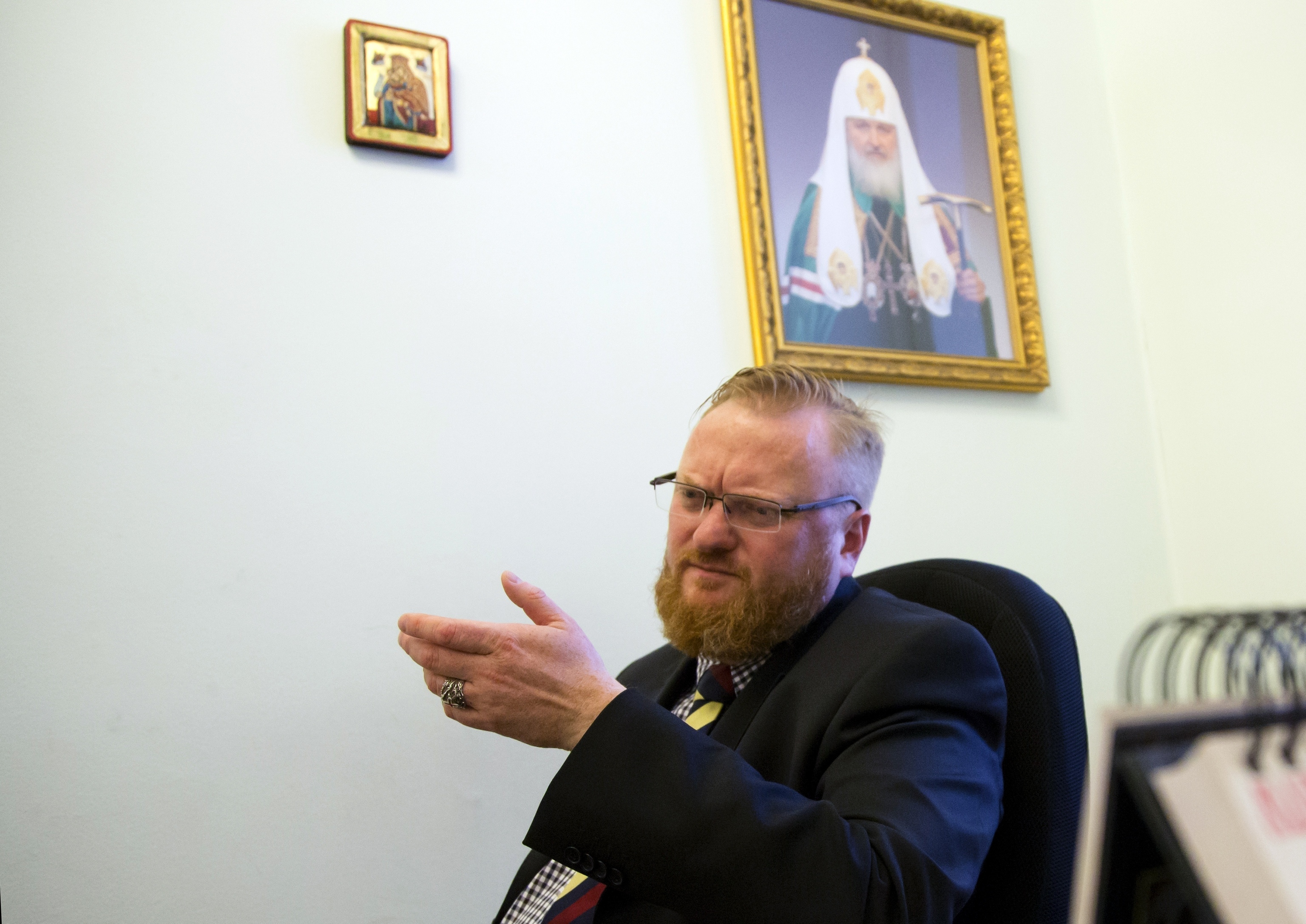El diputado ultraconservador Vitaly Milonov, bajo la foto de un patriarca ortodoxo.