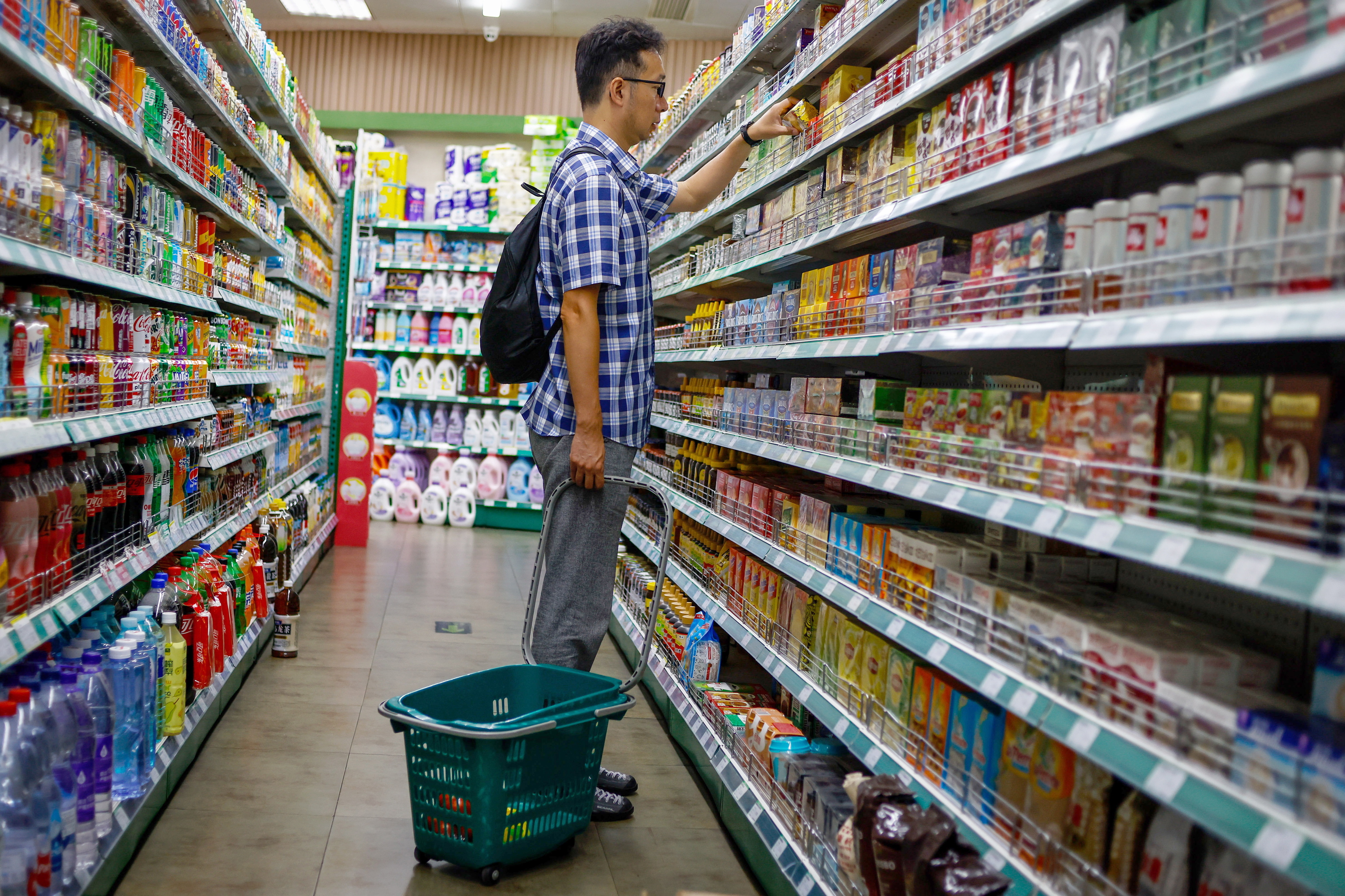 Un hombre mira productos en un supermercado en Beijing, China.