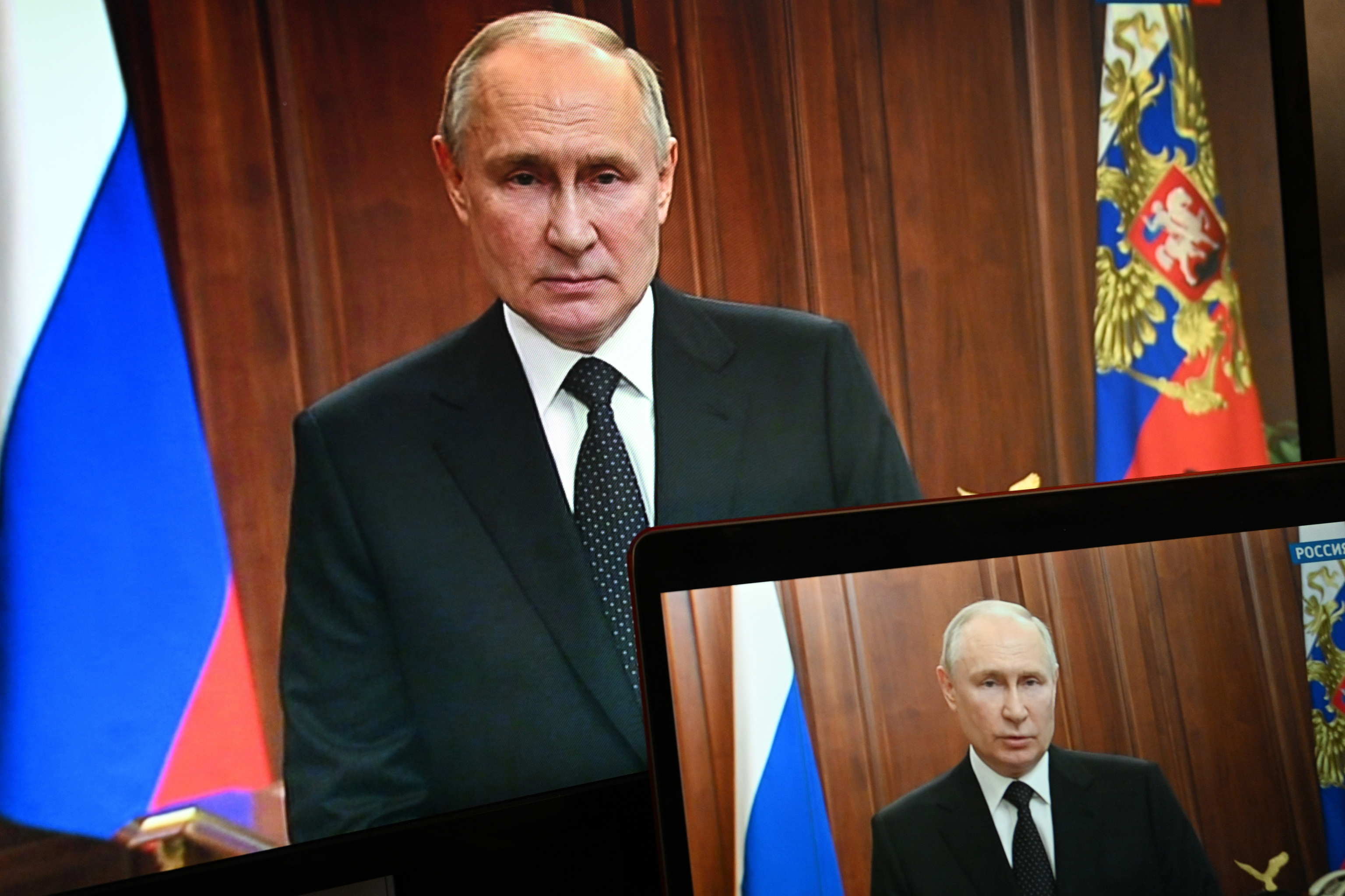 Russian President Vladimir Putin is seen on monitors in Moscow, Russia, on Saturday, June 24, 2023.