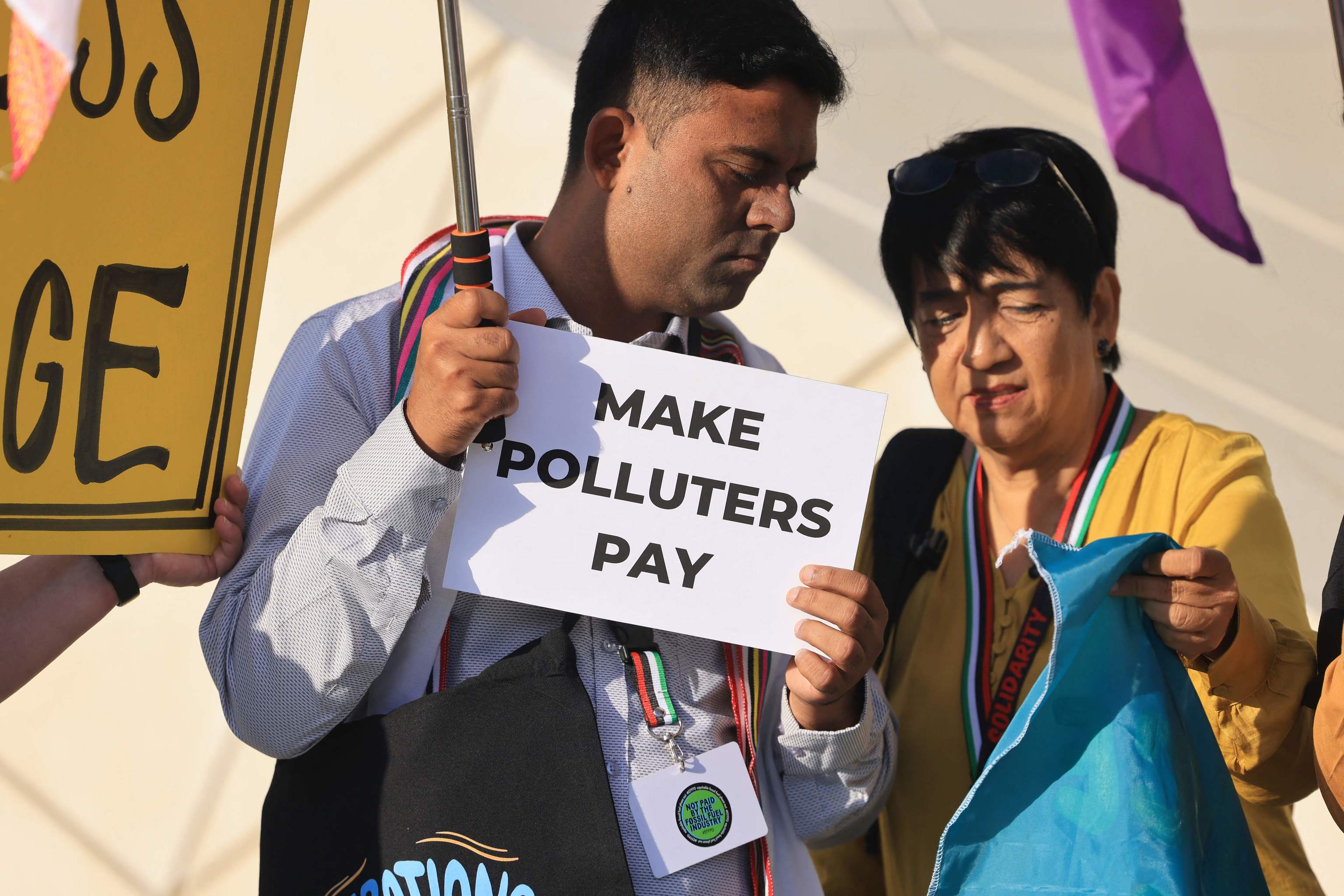 Activistas muestran pancartas este domingo en Dubi en el marco de la COP28.